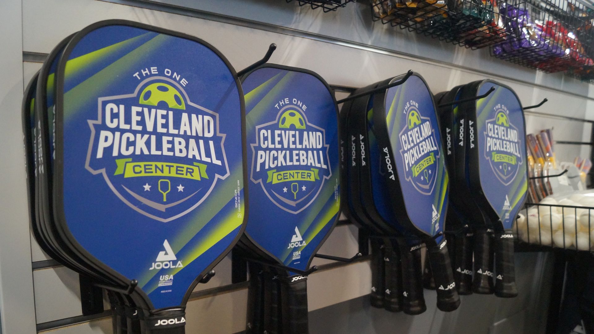 Pickleball paddles hanging on wall