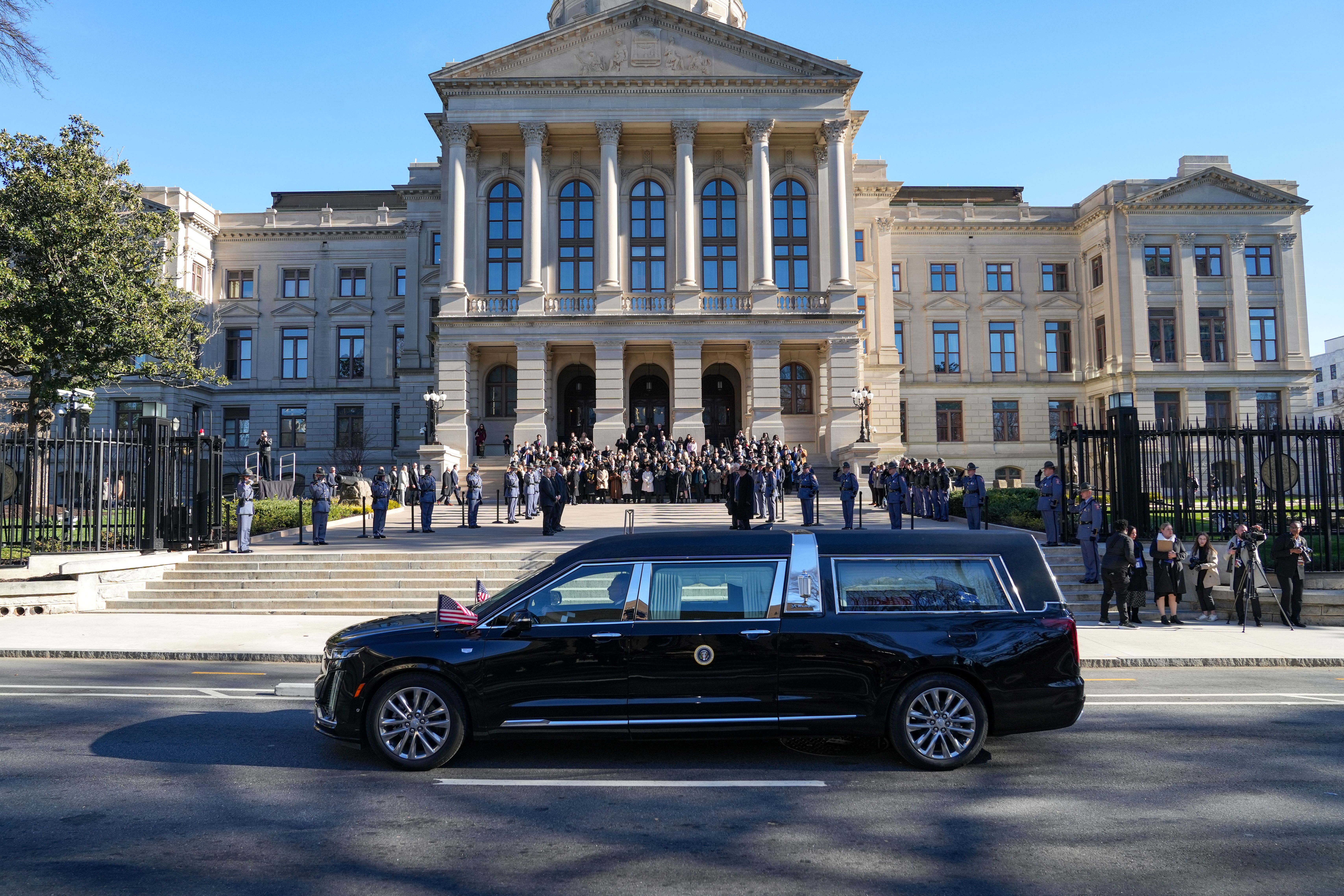 A motorcade carrying the casket of former U.S. President Jimmy Carter pulls up to the Georgia State Capitol building to be honored with a moment of silence on January 4, 2025 in Atlanta, Georgia. The motorcade of the former president, who served as Governor of Georgia from 1971 to 1975 and in the Ge