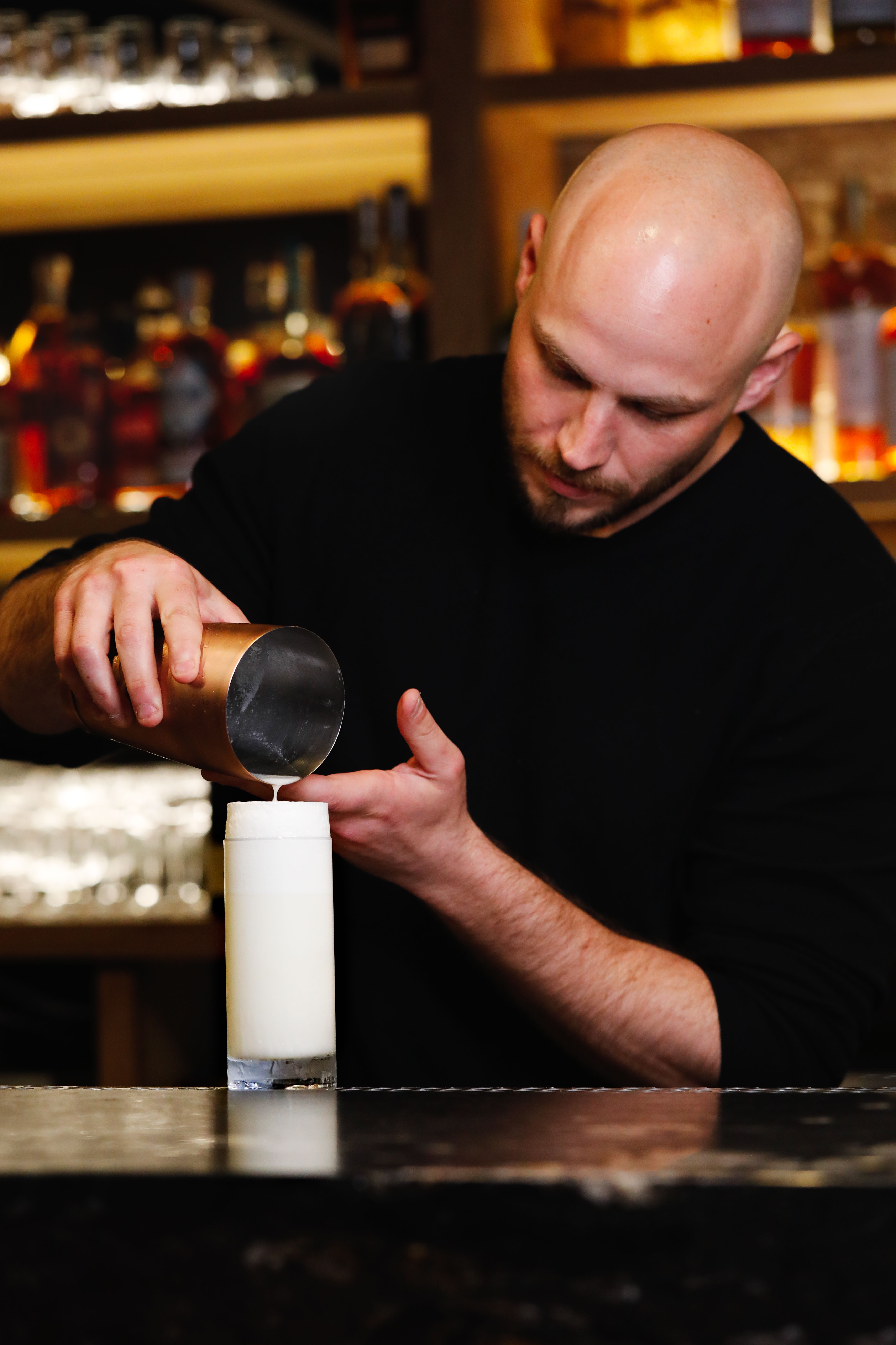 a bartender pouring a drink