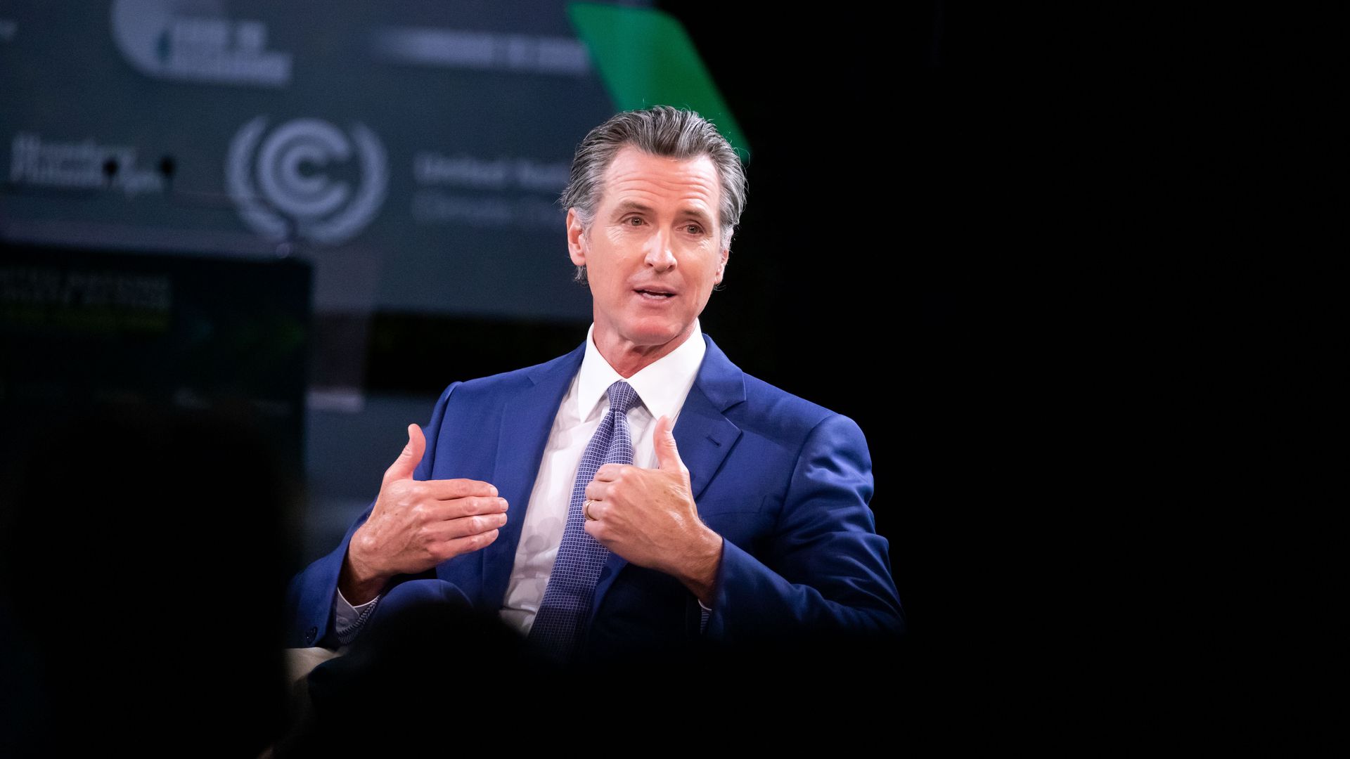 Photo of Gavin Newsom speaking while gesturing with his hands