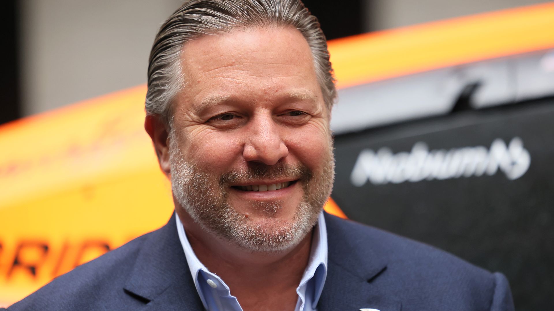 Zak Brown, CEO of McLaren Racing, poses for a photo in front of the MX Extreme E race car outside of the New York Stock Exchange.