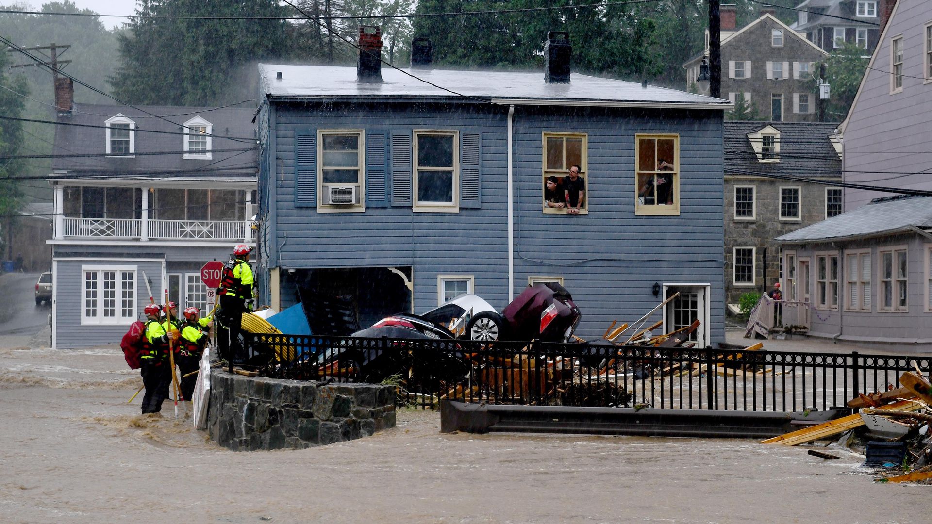 Rescuers work to free people trapped upstairs from a record store during torrential rain that caused flash floods along Main Street May 27, 2018 in Ellicott City, Maryland.