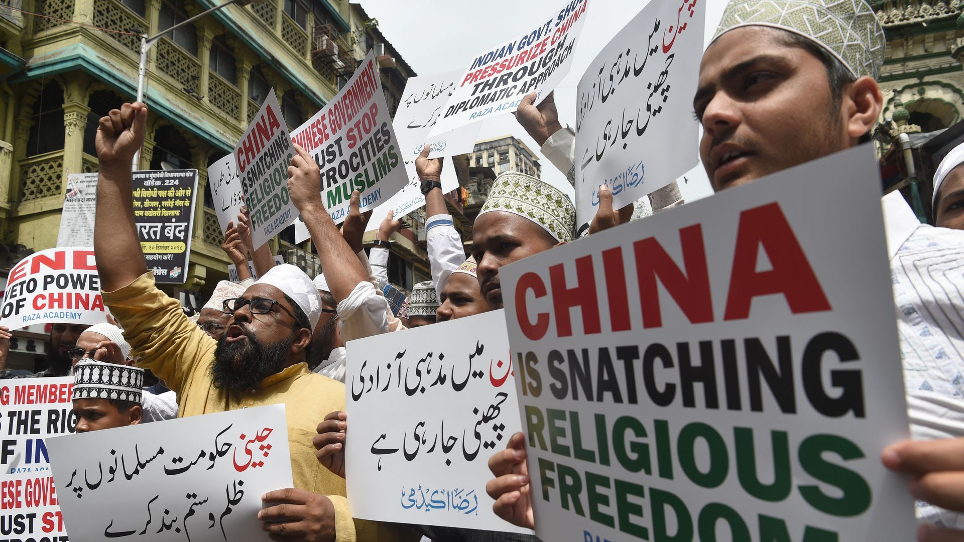Protesters with signs about China snatching religious freedom