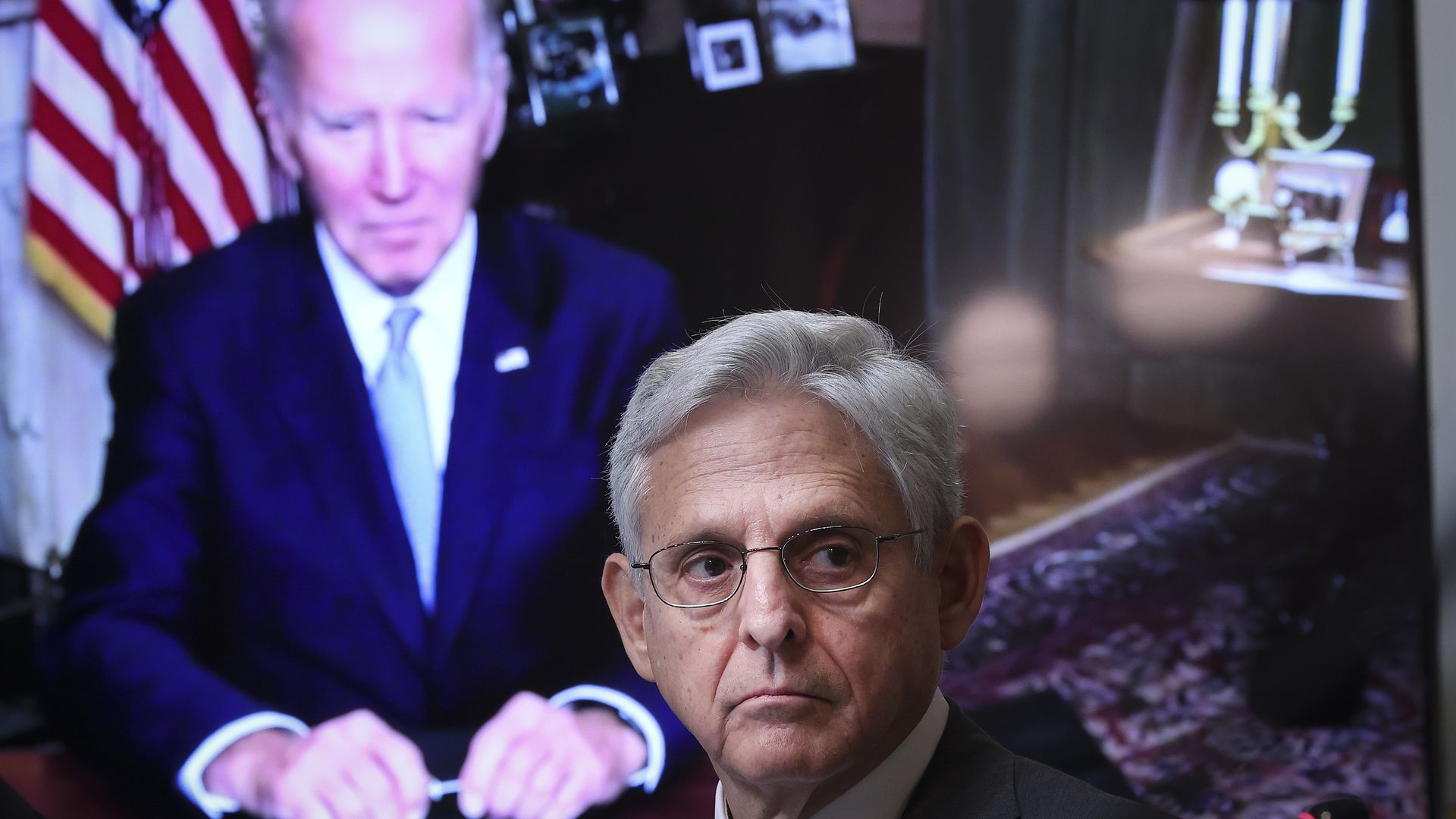 President Joe Biden, appearing via teleconference, looks on Attorney General Merrick Garland attends a meeting of the Task Force on Reproductive Healthcare Access during an event at the White House complex August 3, 2022 in Washington, DC. 