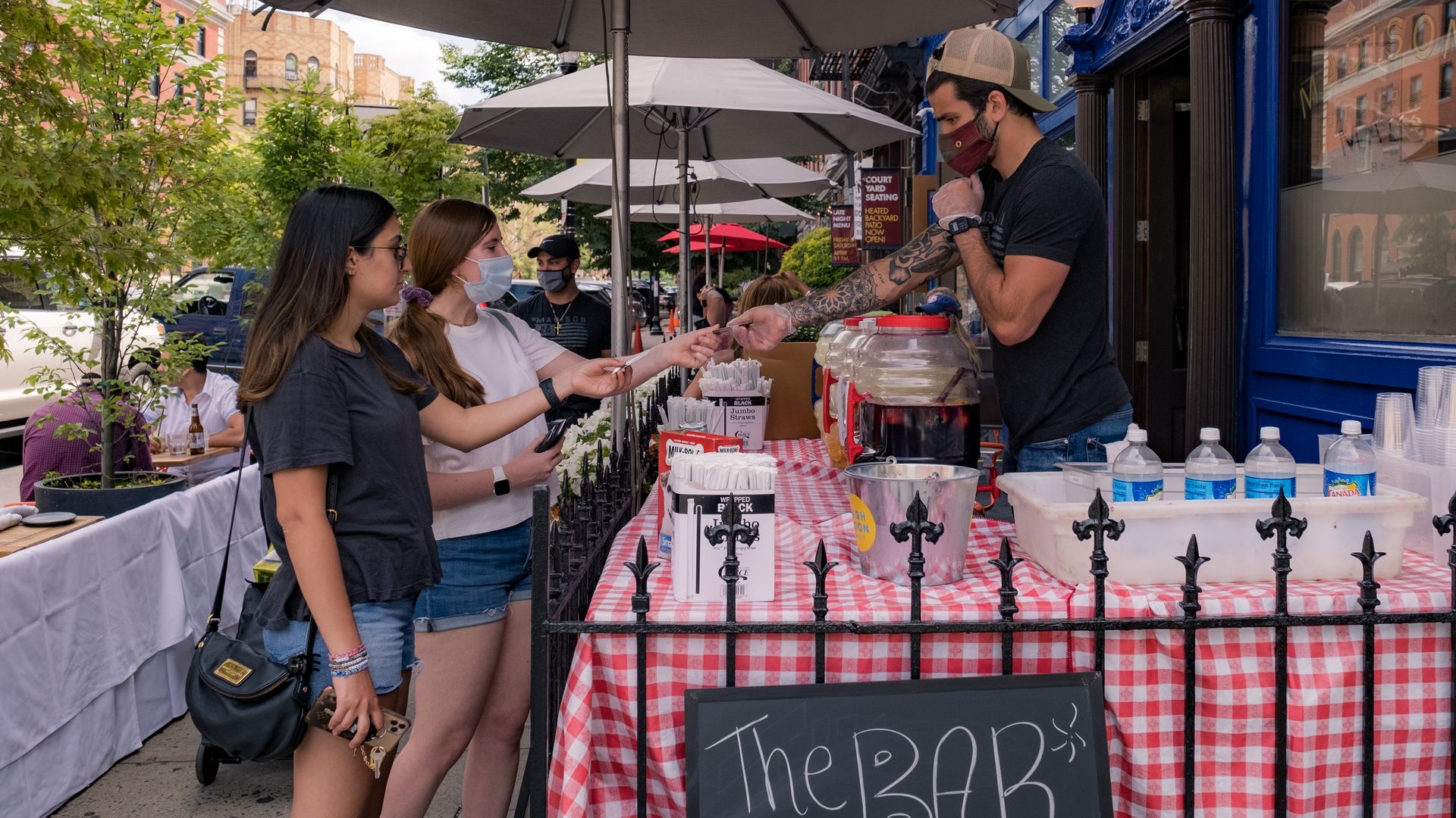 Customers order a drinks to-go outside a restaurant as the city reopens from the coronavirus lockdown on June 15, 2020 in Hoboken, New Jersey.