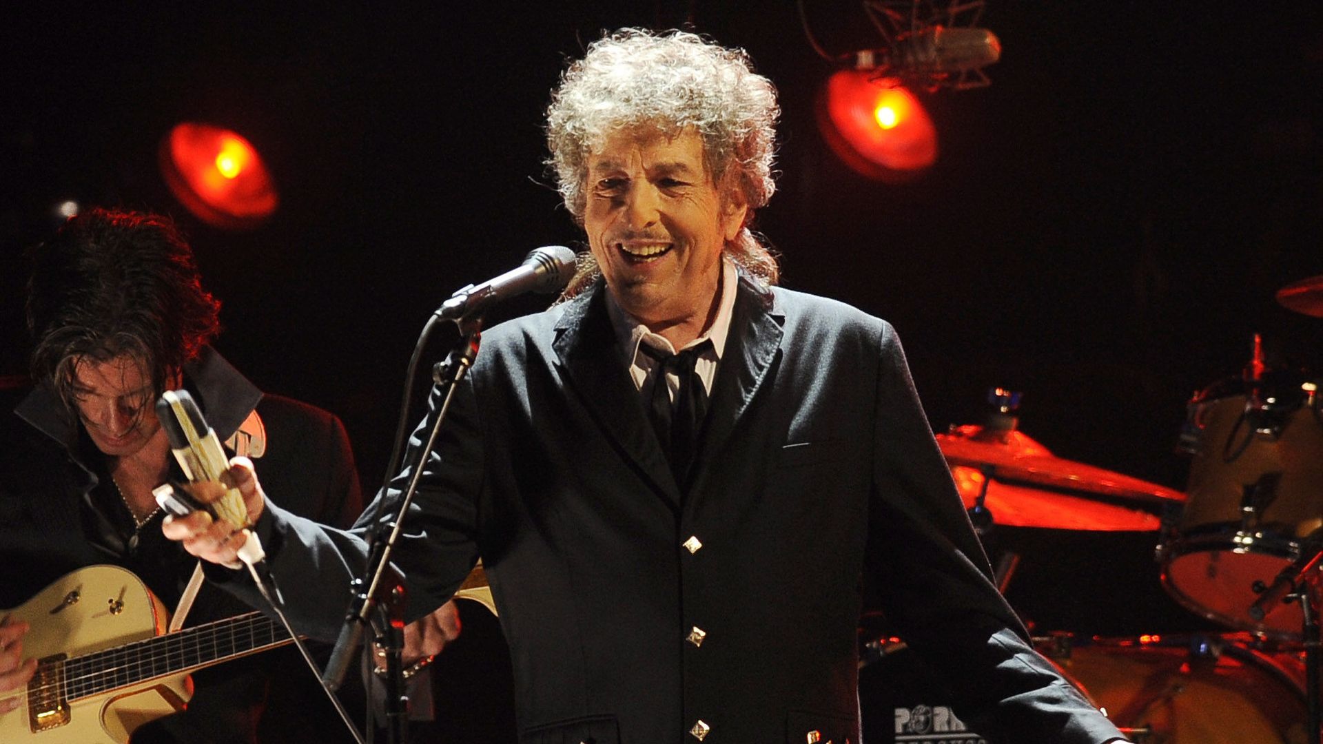 Bob Dylan smiling on stage
