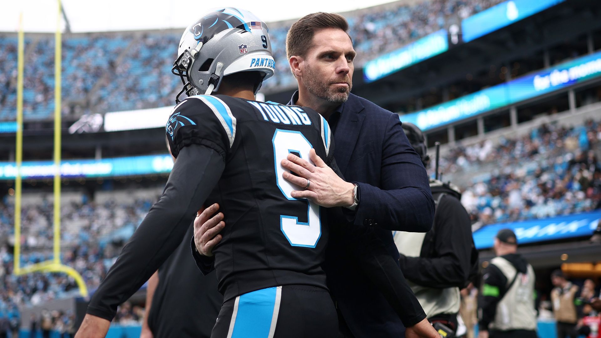 Dan Morgan, president of football operations and general manager for the Carolina Panthers, embraces Bryce Young #9 prior to the NFC Wild Card Playoff game against the Los Angeles Rams at Bank of America Stadium on January 10, 2026 in Charlotte, North Carolina. (Photo by Jared C. Tilton/Getty Images