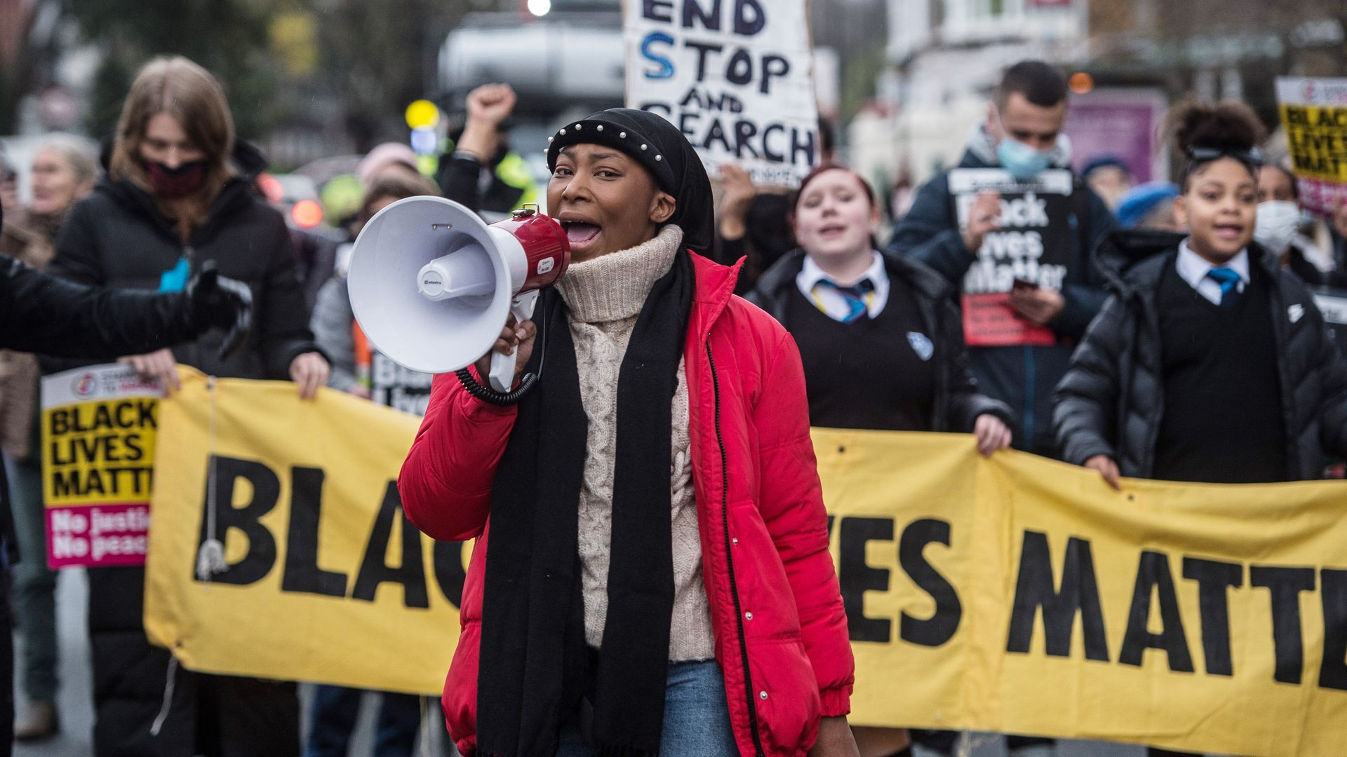 Photo of Sasha Johnson speaking into a megaphone and leading a BLM crowd