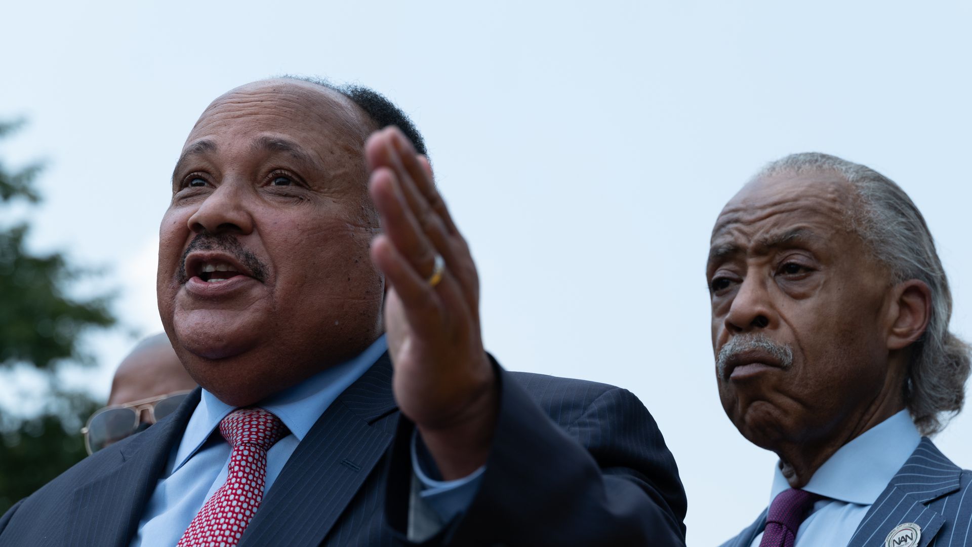 Martin Luther King III speaks, with Rev. Al Sharpton behind him, at a press conference at the Martin Luther King, Jr. Memorial on July 28, 2021 in Washington, DC.