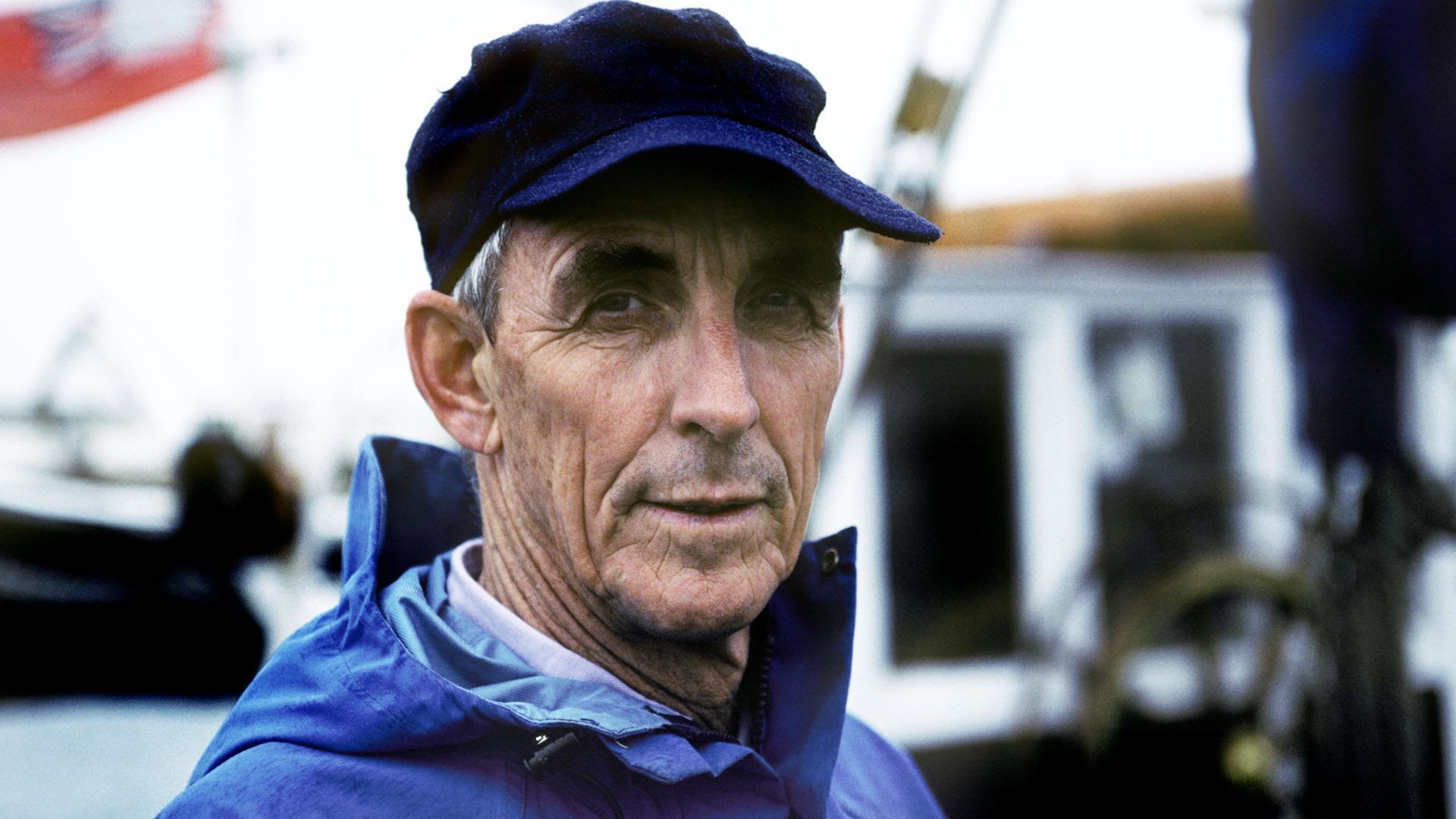 A portrait of the author Peter Matthiesen in 1992 wearing a blue windbreaker.