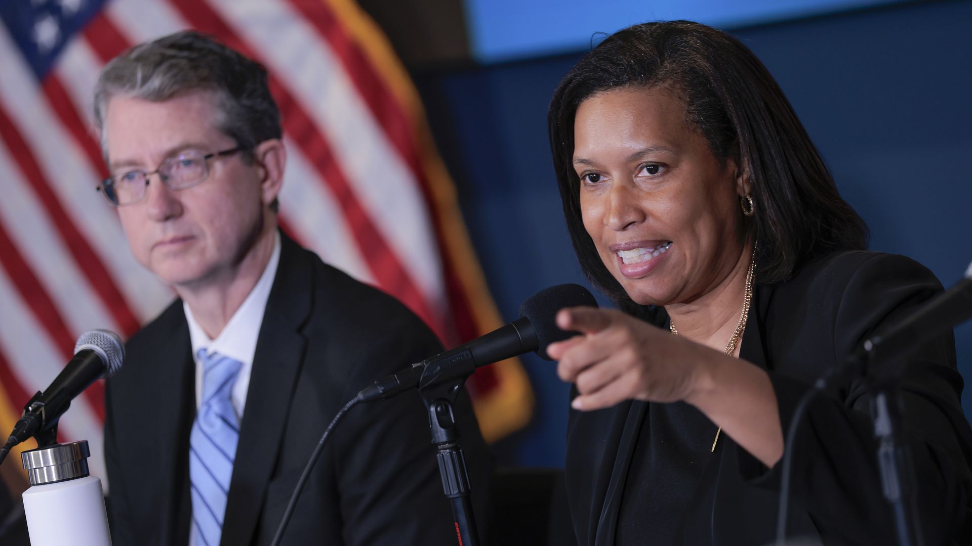 Kevin Donahue and Muriel Bowser sitting in front of microphones 
