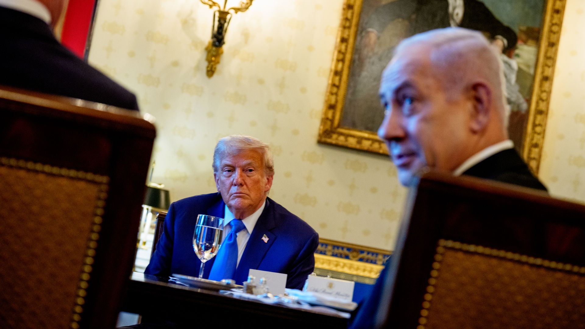 Trump looks at Netanyahu who is looking away.