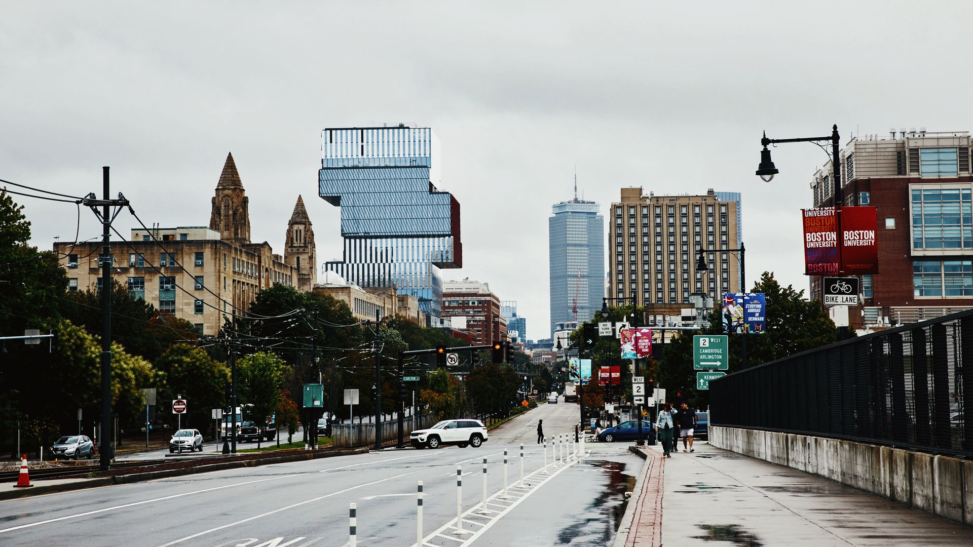 The Center for Computing & Data Sciences building at Boston University, a tall glass structure with stacked, cantilevered floors, rises above Commonwealth Avenue in Boston.