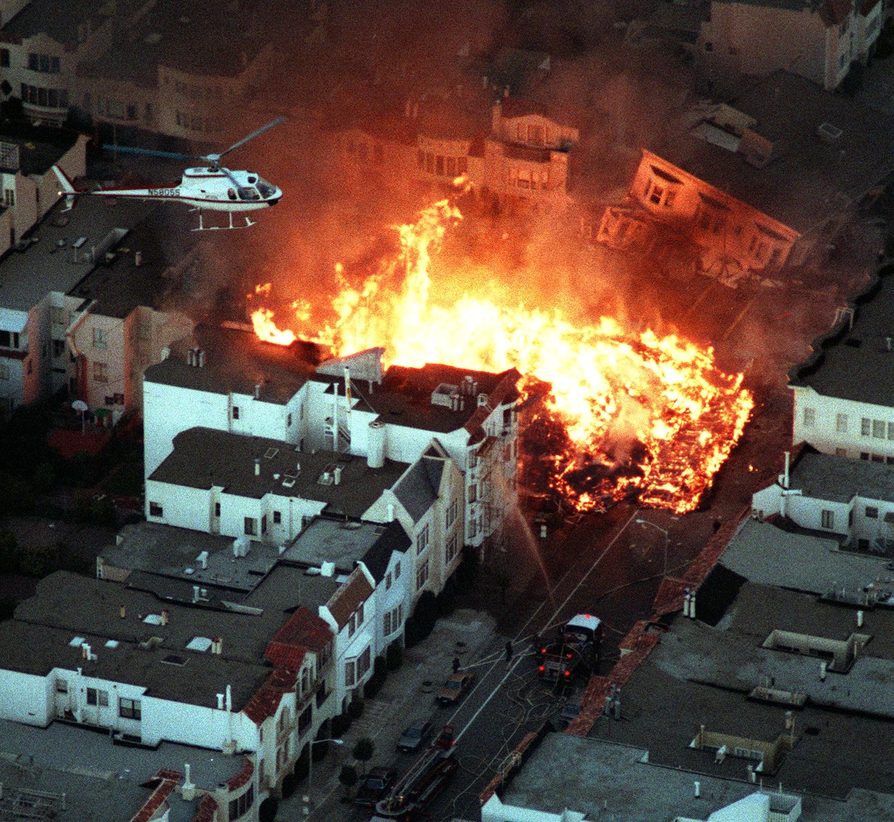 Photo of a fire overtaking an apartment complex