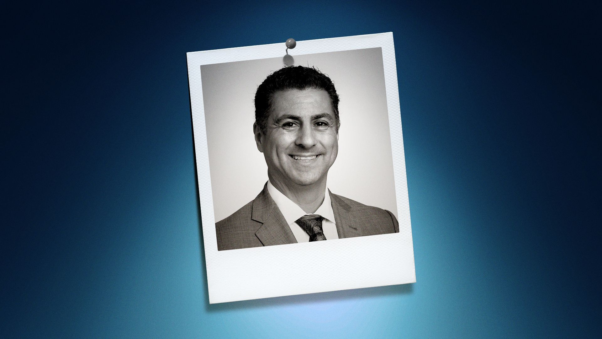 Photo illustration of Jaime Gomez in the center of a Polaroid photo under a blue spotlight.