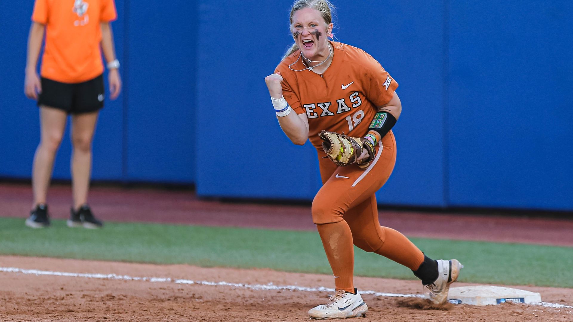 A UT Longhorns softball player celebrates.