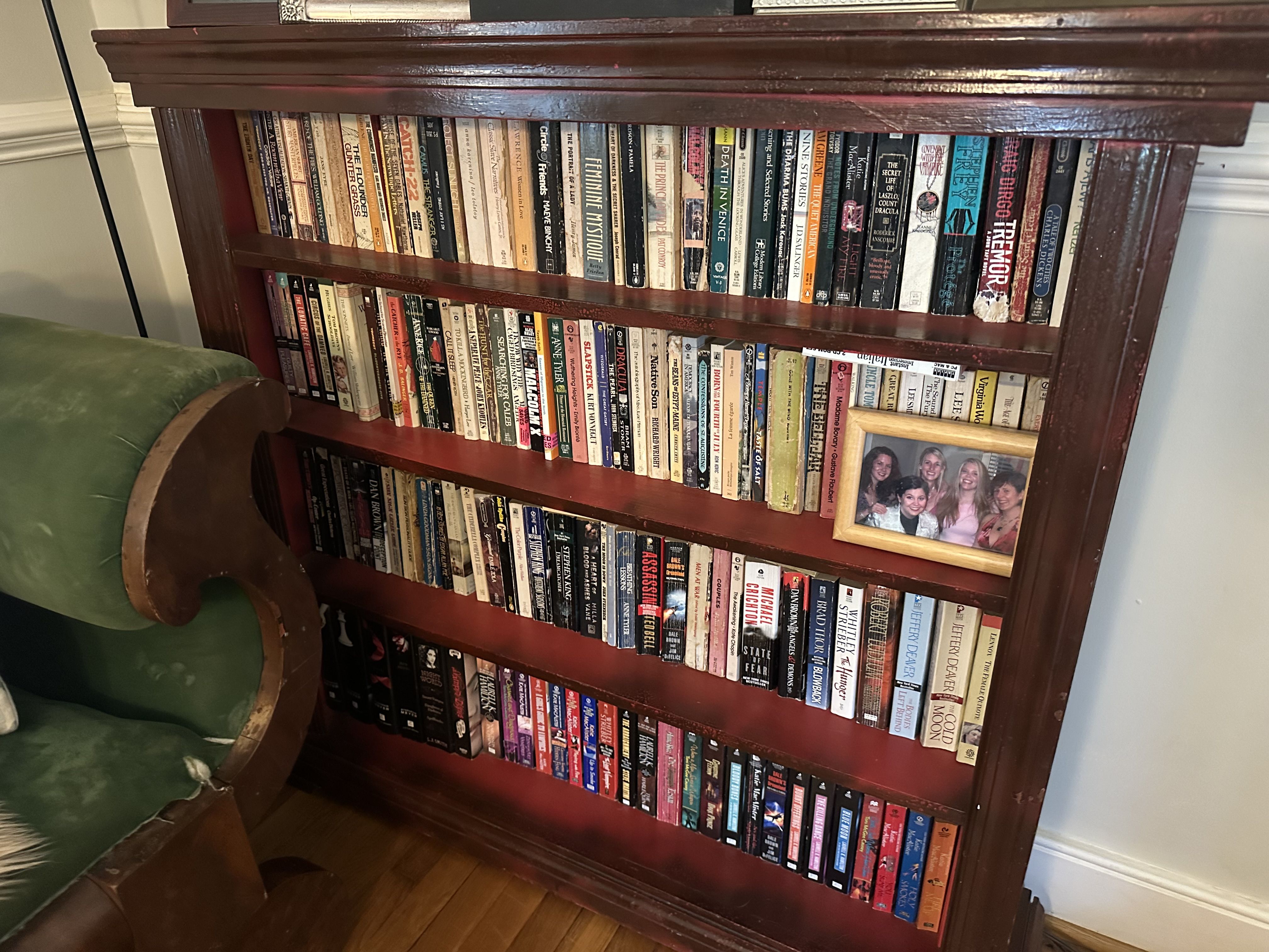 A small bookcase crammed with paperbacks 
