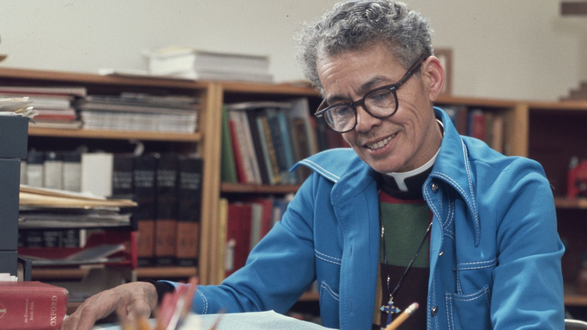 Pauli Murray writing at a desk.