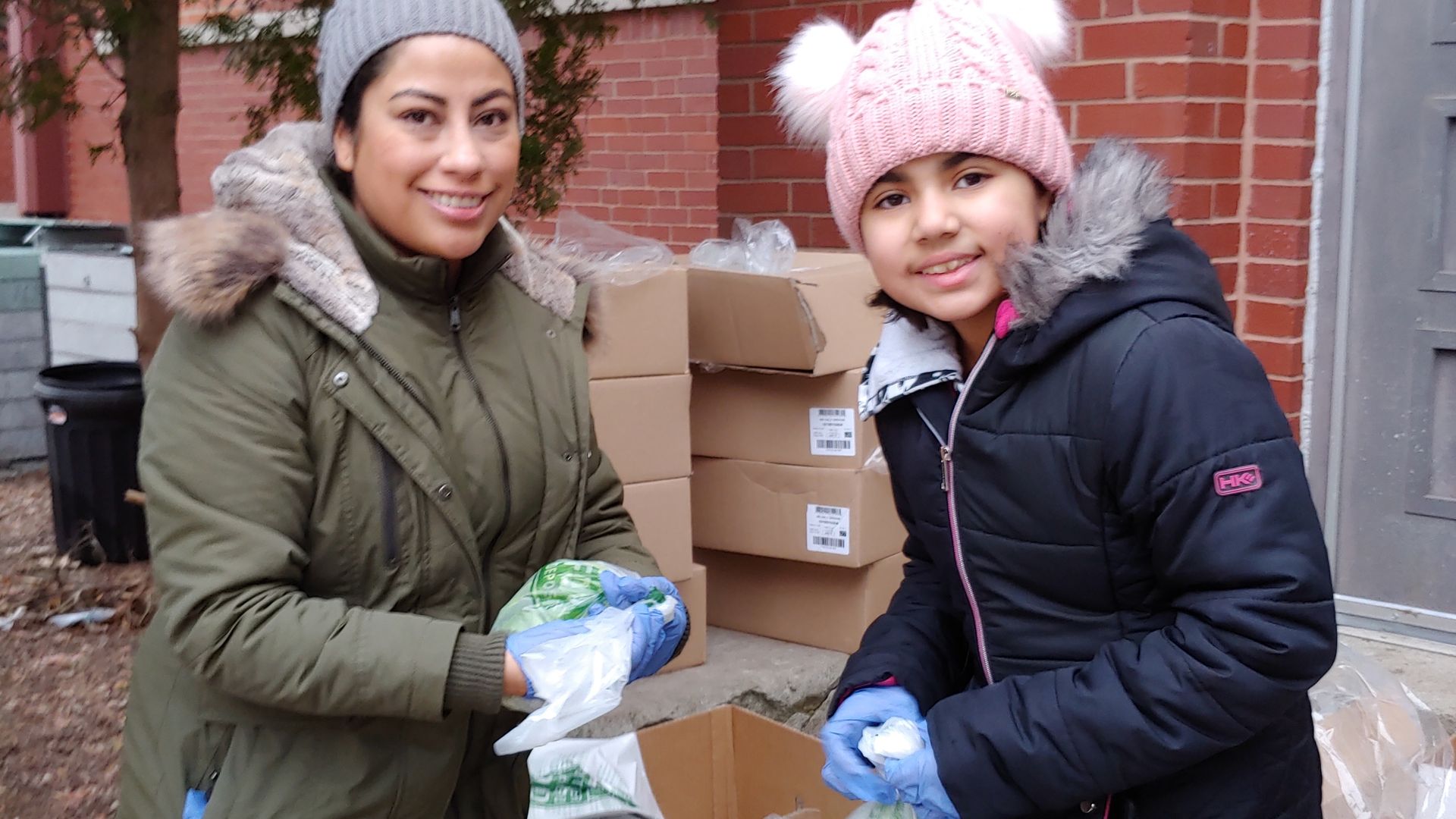 Two people packing lettuce in a box.