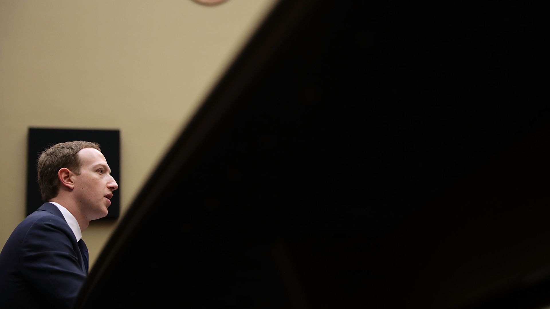 Mark Zuckerberg testifying in congress, with the photo shot from a low angle