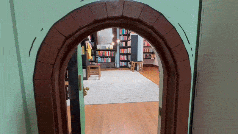 A children's size door swings open in a bookstore
