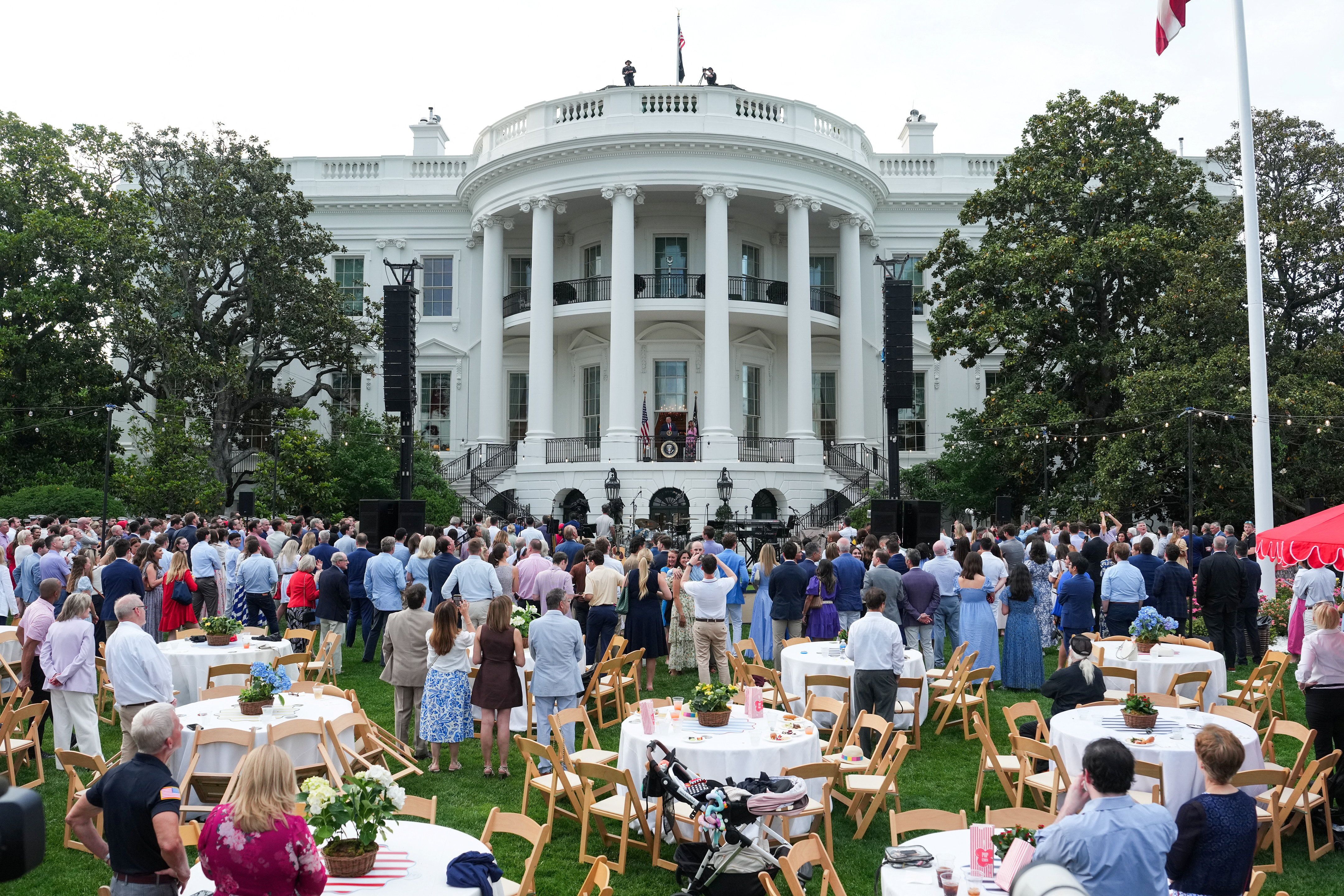 Guests watch President Donald Trump speak during the Congressional Picnic on the South Lawn last evening.