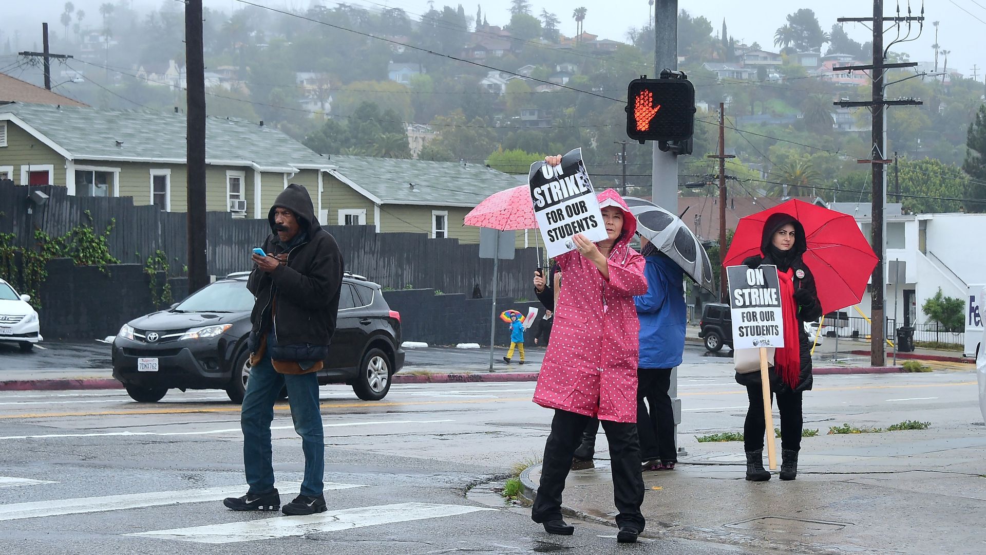 Los Angeles Unified School District (LAUSD) display their On Strike signs to passing vehicles on Sunset Boulevard in Los Angeles