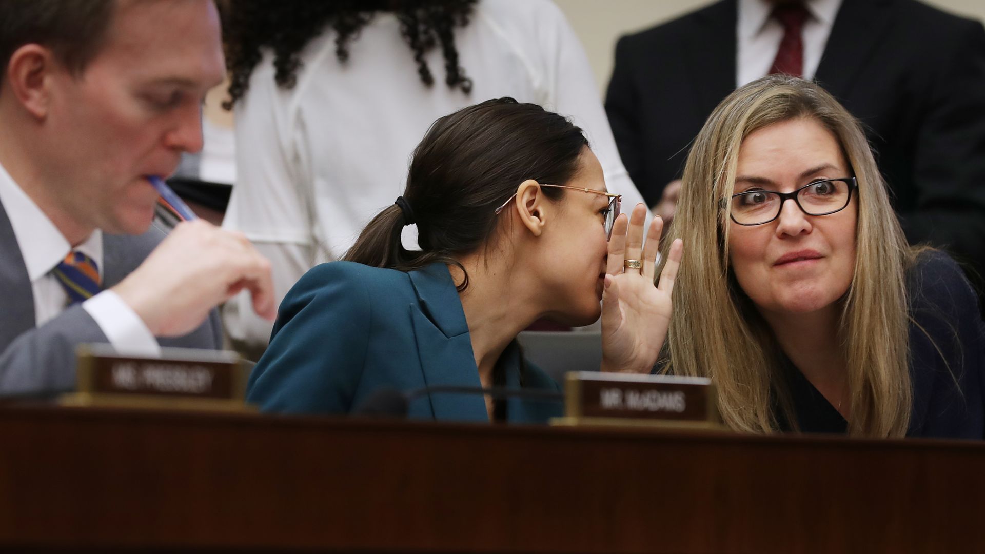 House Financial Services Committee members Rep. Alexandria Ocasio-Cortez (D-NY) (C) talks with Rep. Jennifer Wexton (D-VA) while hearing testimony from former Wells Fargo and Company CEO Timothy Sloan