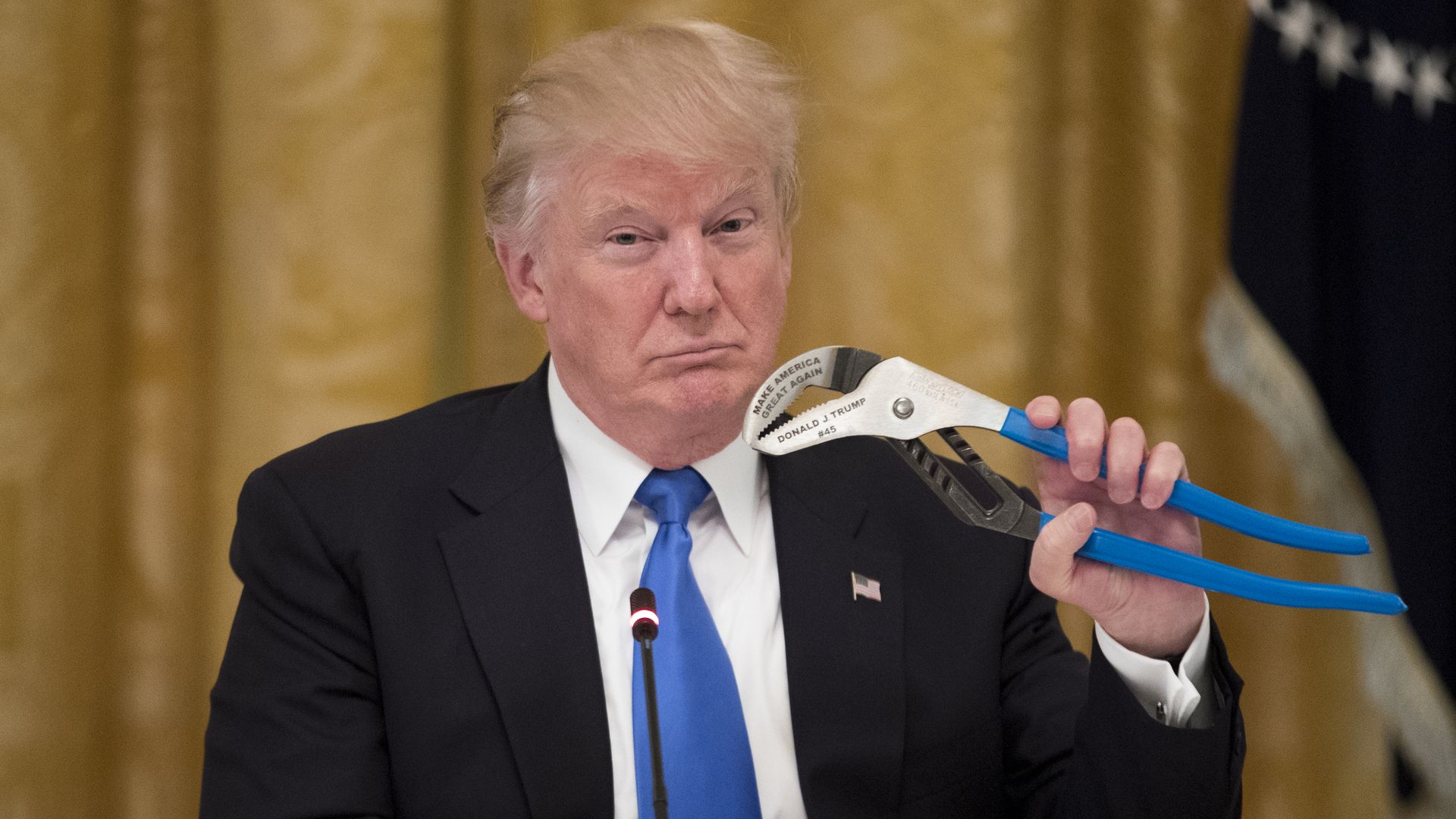 Trump holds a Channellock Inc. wrench engraved with his name and "Make America Great Again" during a meeting.