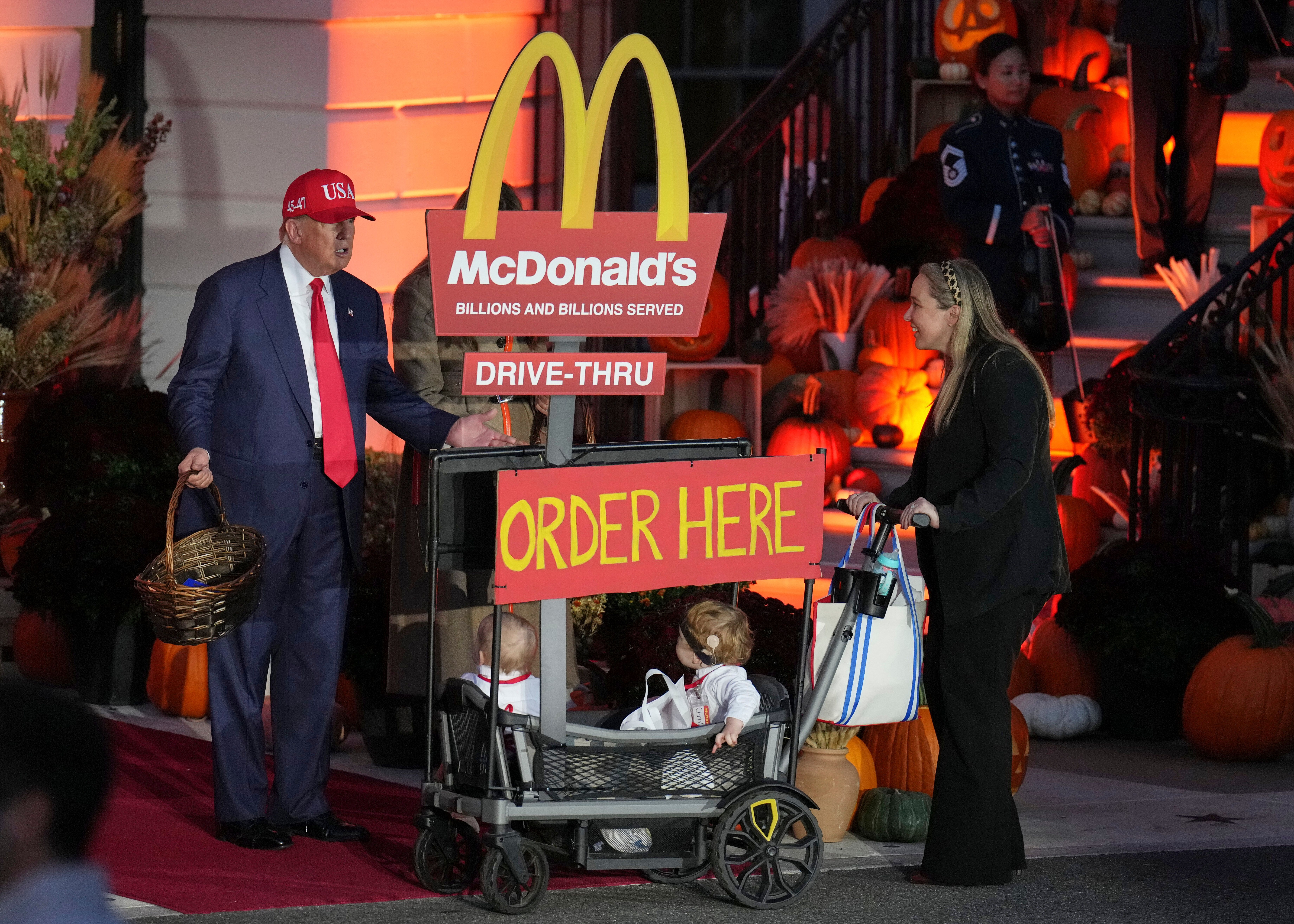 President Trump greets a family dressed as workers at a McDonald's drive-through during a Halloween event at the White House last month.