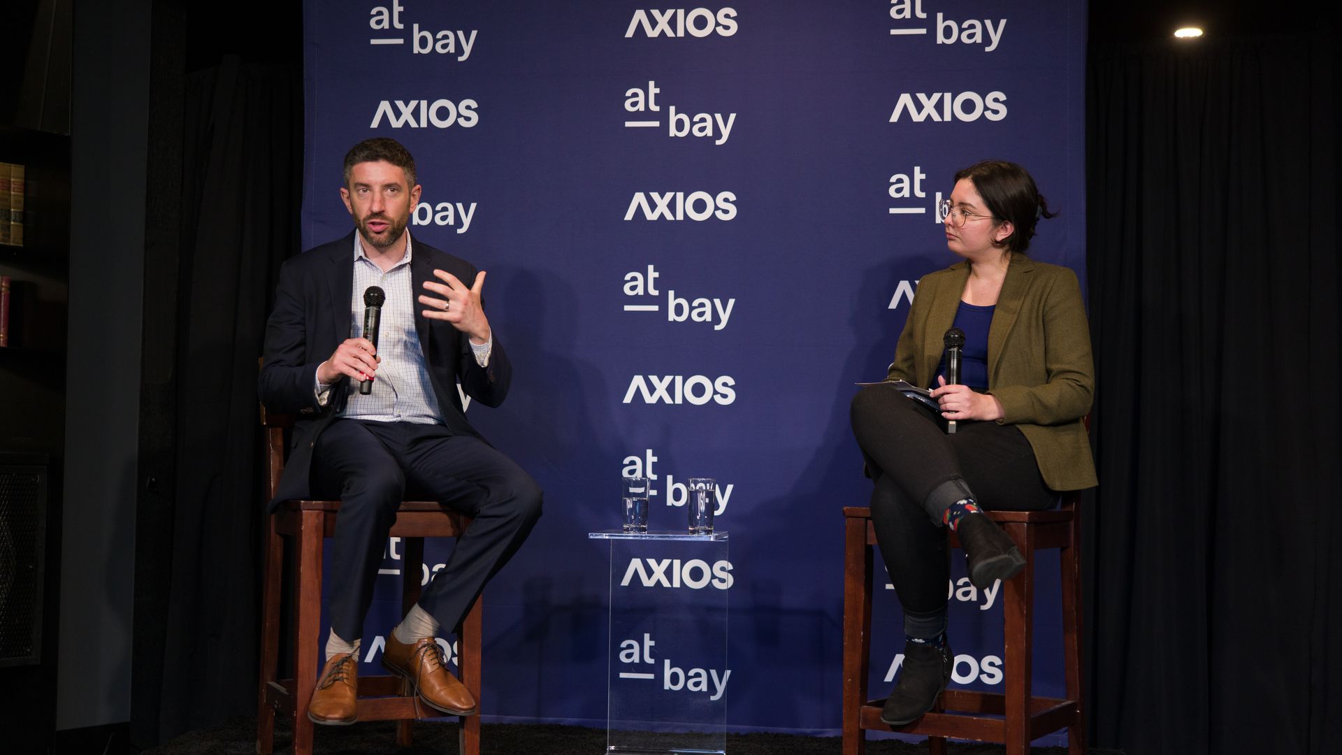 CISA's Eric Goldstein and Axios reporter Sam Sabin speaking during a reception in SF