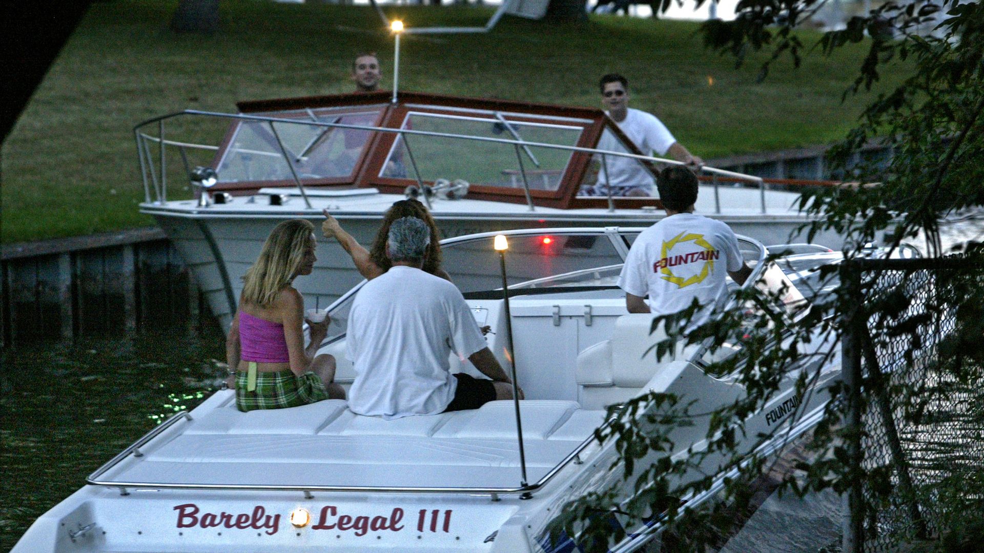 A photo showing two boats passing on a lake