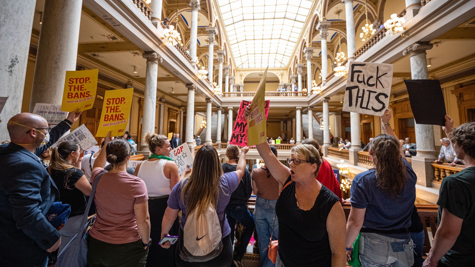 Photo of protesters crowding the Indiana state capital rotunda