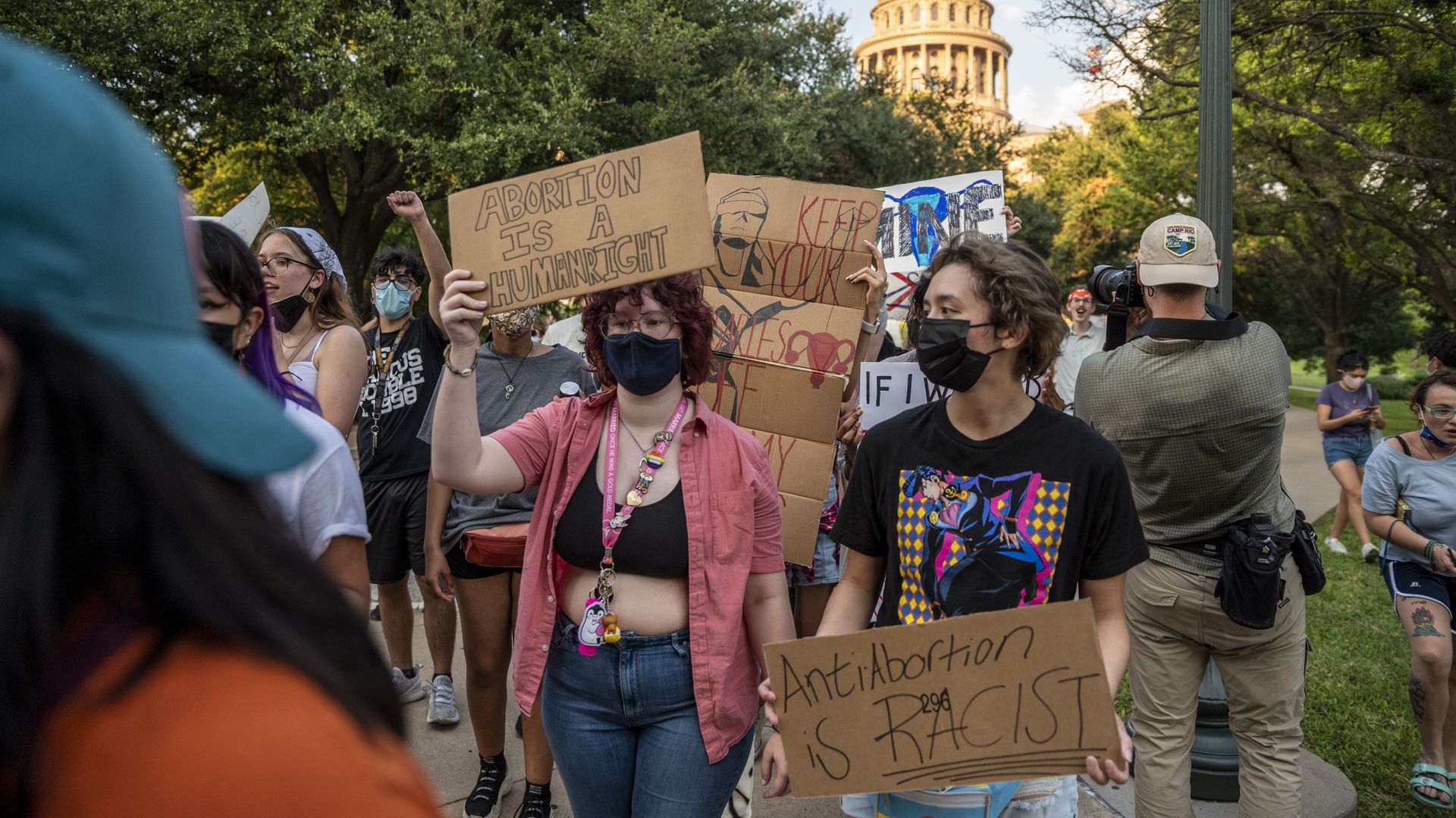 Photo of protesters holding up pro-abortion signs as they crowd outside