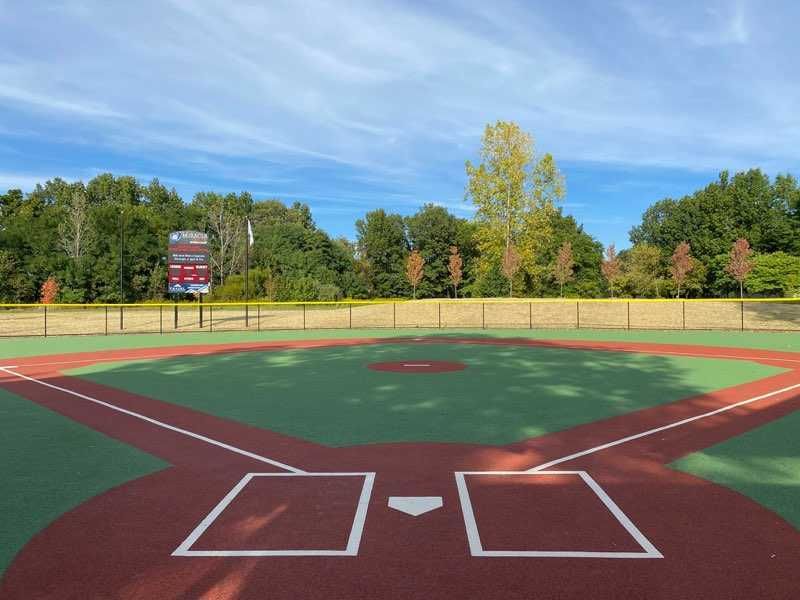 The view of a youth baseball field from home plate. 