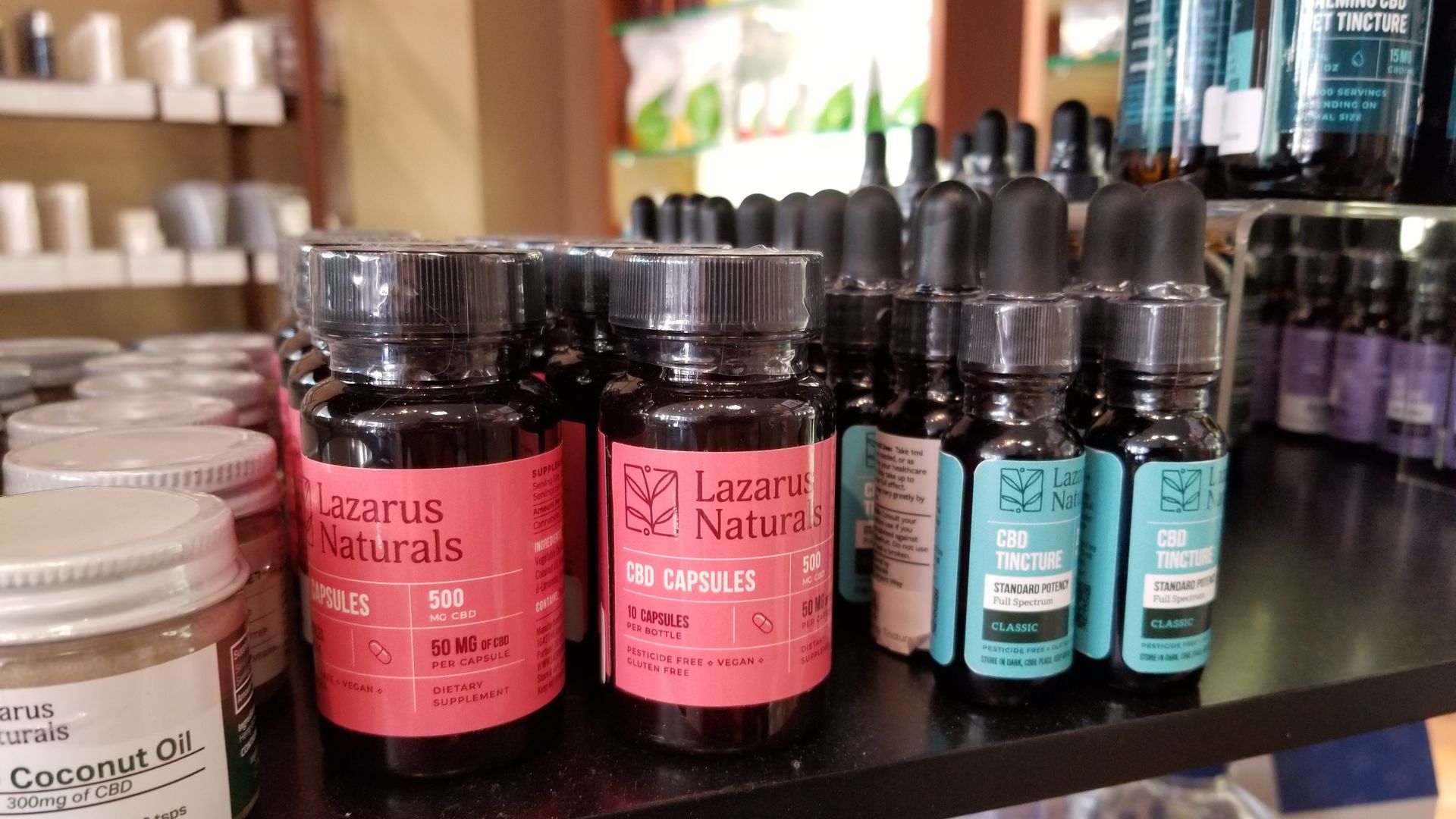 Close-up of Lazarus Naturals products advertising bottles of Cannabidiol or CBD