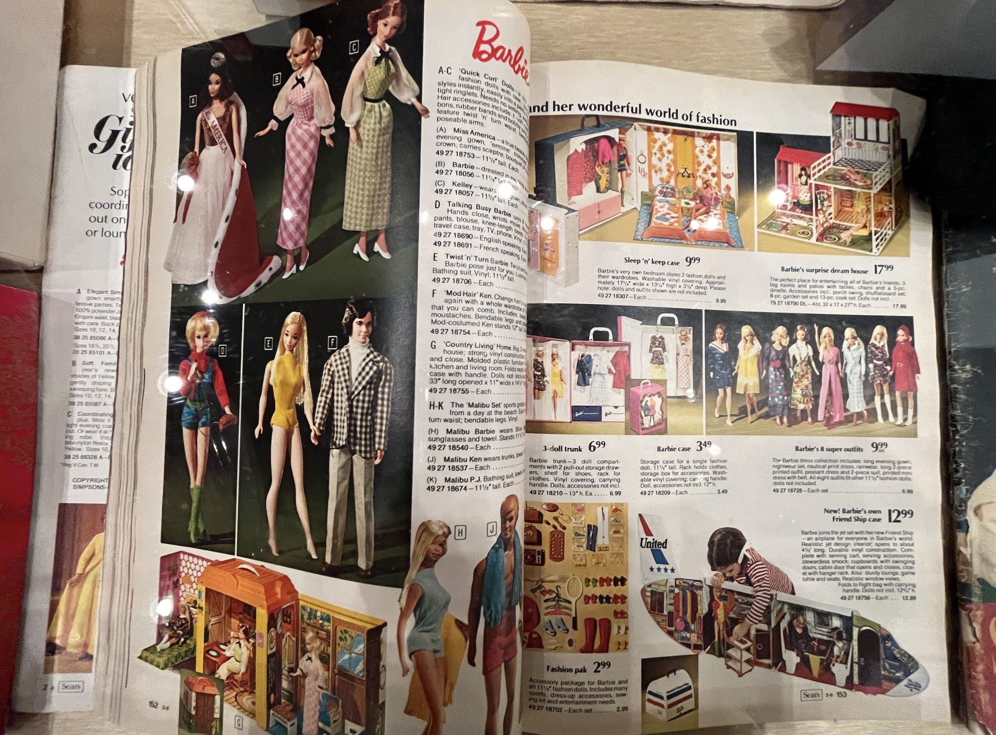 Open catalog with photos of Barbie and other toys.