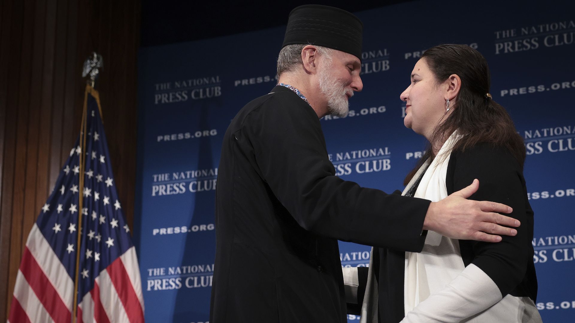 Archbishop Borys Gudziak (L) of the Ukrainian Catholic Archeparchy of Philadelphia embraces Ukrainian Ambassador to the United States Oksana Markarova at the conclusion of a press conference.