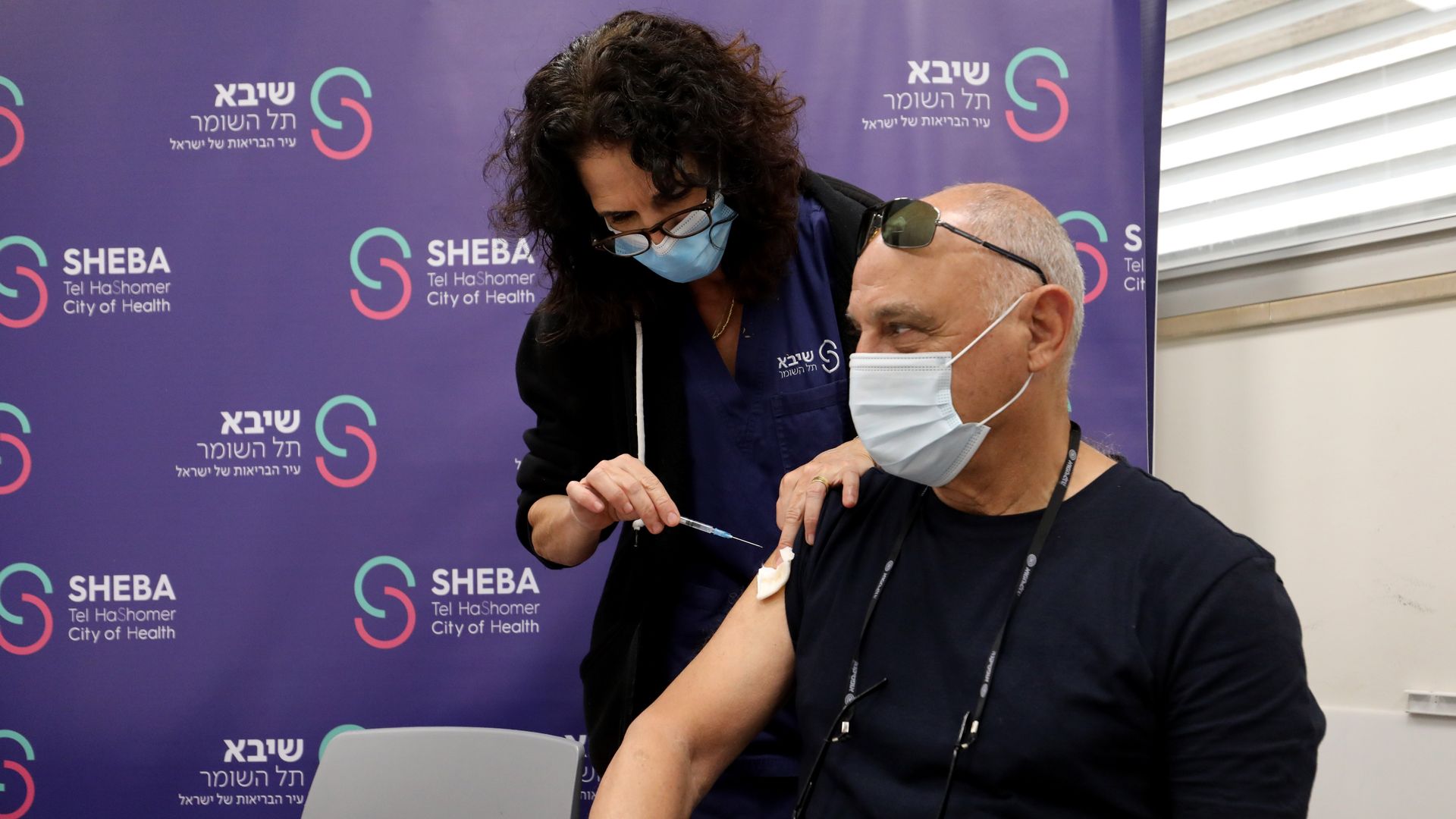 An Israeli man receives the fourth dose of COVID-19 vaccine at Sheba Medical Center