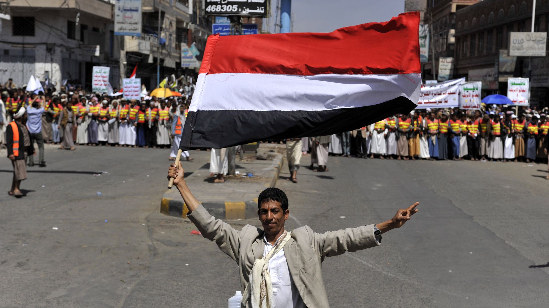 A supporter of Yemen's Shiite Houthi group waves Yemeni flag in Sanaa, Yemen on September 1, 2014. Photo: Mohammed Hamoud/Anadolu Agency/Getty Images.