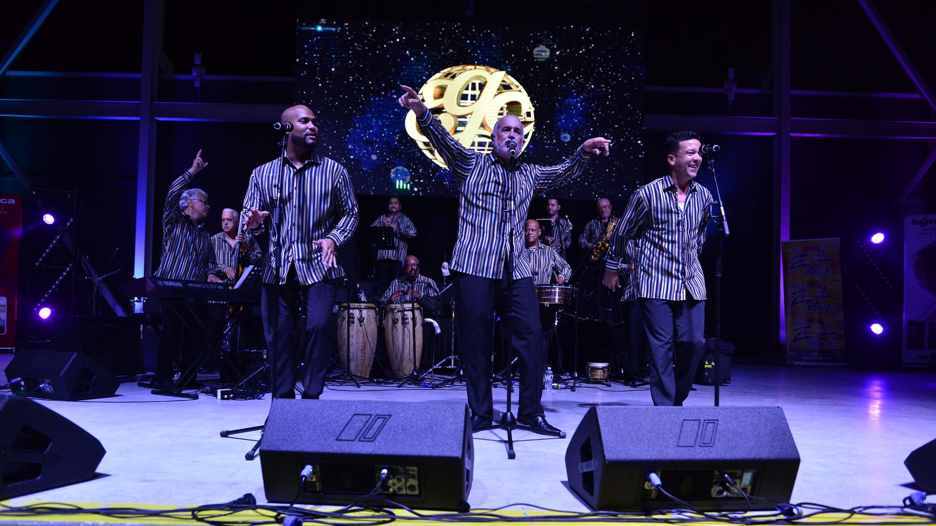 Jerry Rivas, center, holds up his hands while singing as he and El Gran Combo De Puerto Rico performs on stage during Festival De La Zalsa at Miramar Regional Park Amphitheater on May 1, 2021 in Miramar, Florida.