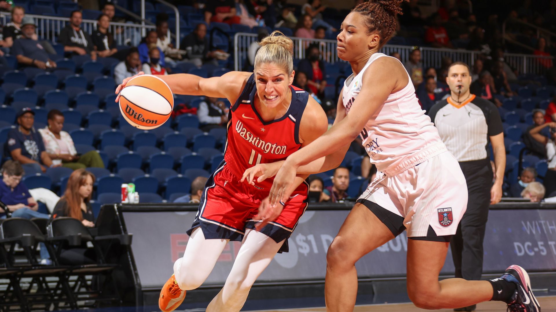 Elena Delle Donne dribbles a basketball past a defender.