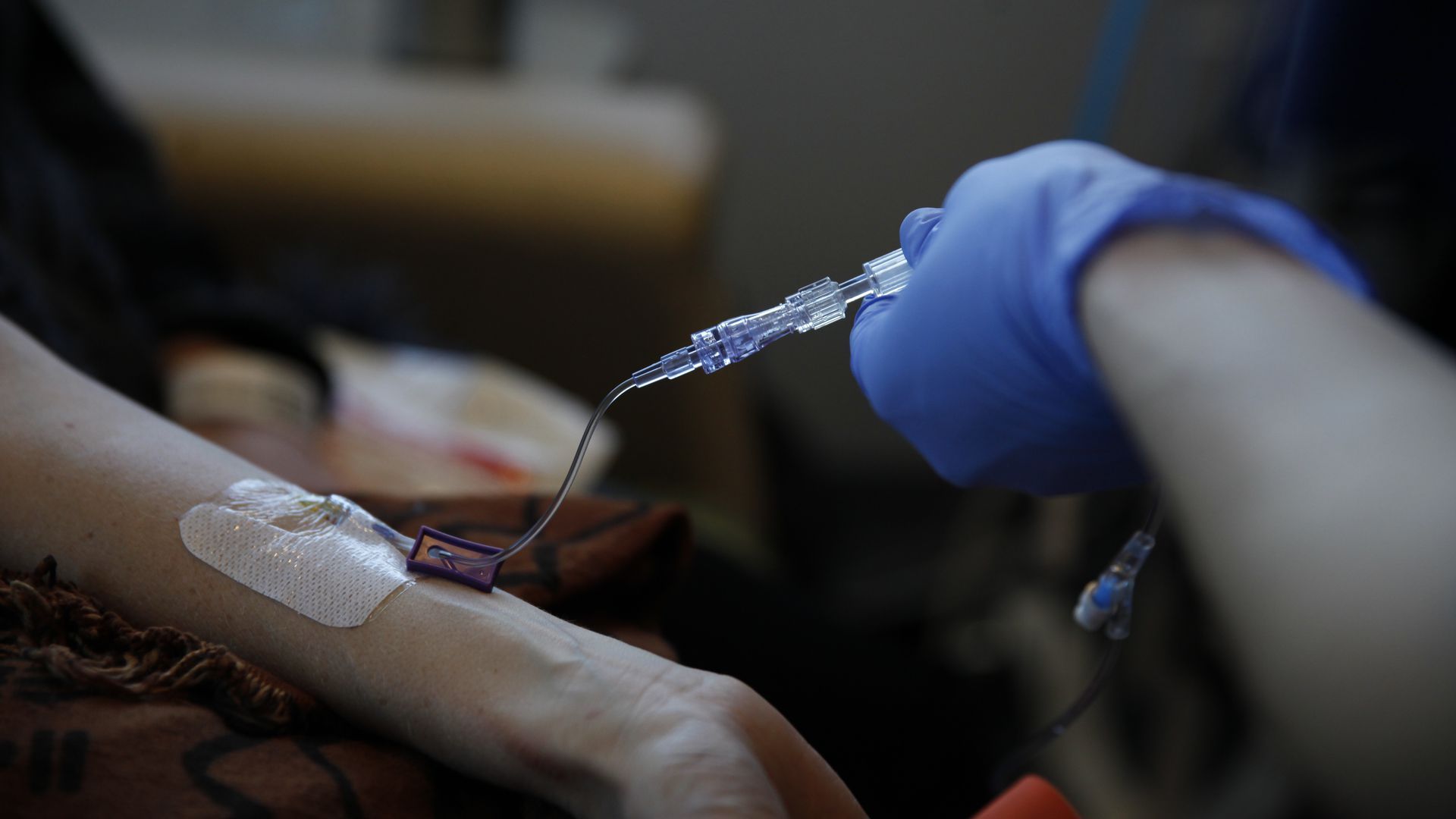 A nurse administers an IV.