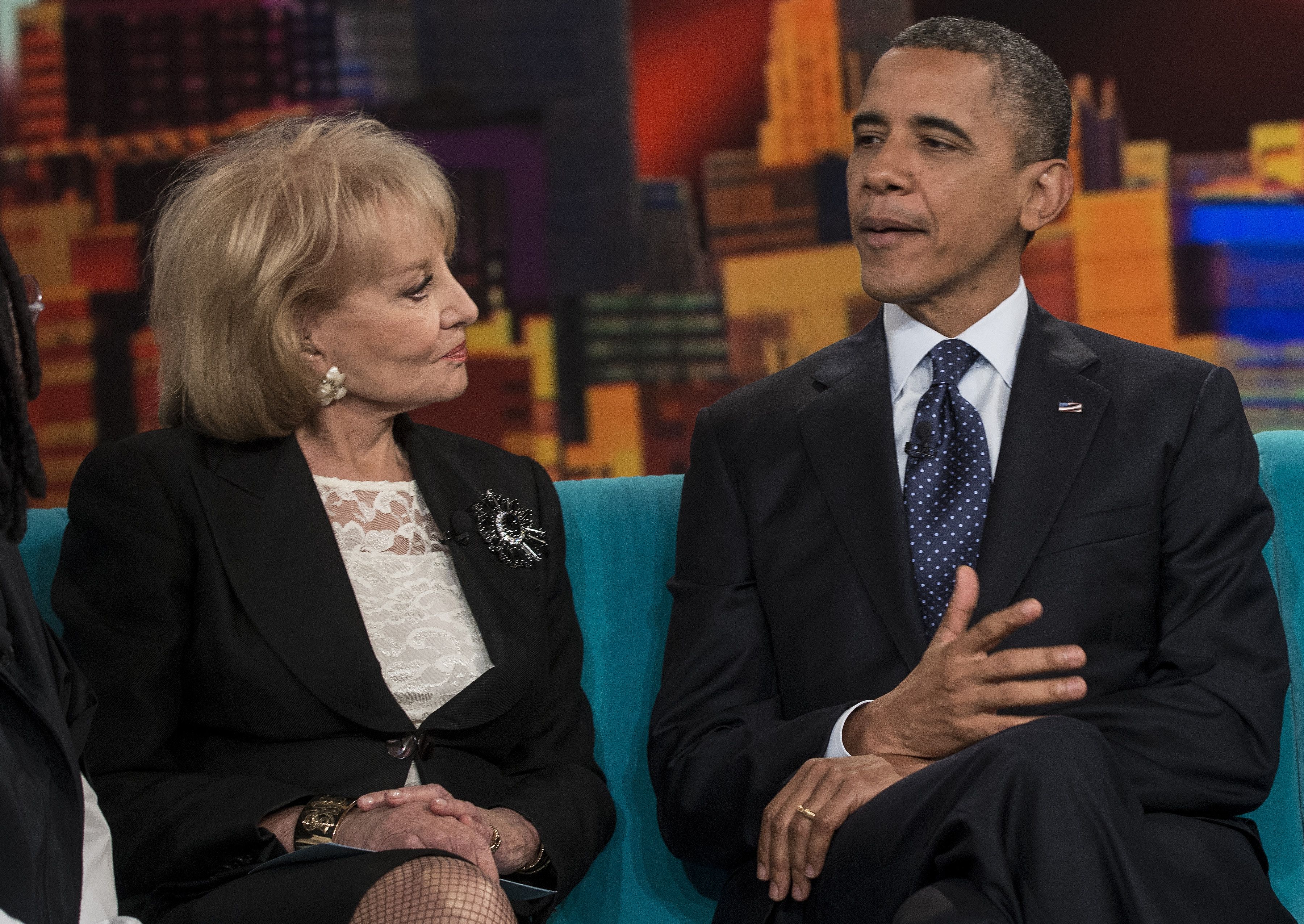 Barbara Walters listens as US President Barack Obama speaks during a break in a taping of "The View" at ABC Studios September 24, 2012 in New York, New York.