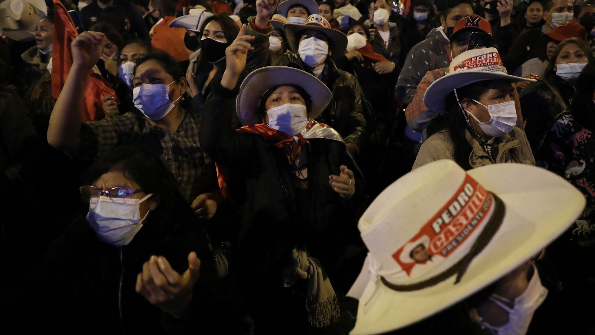 A masked crowd of individuals at night