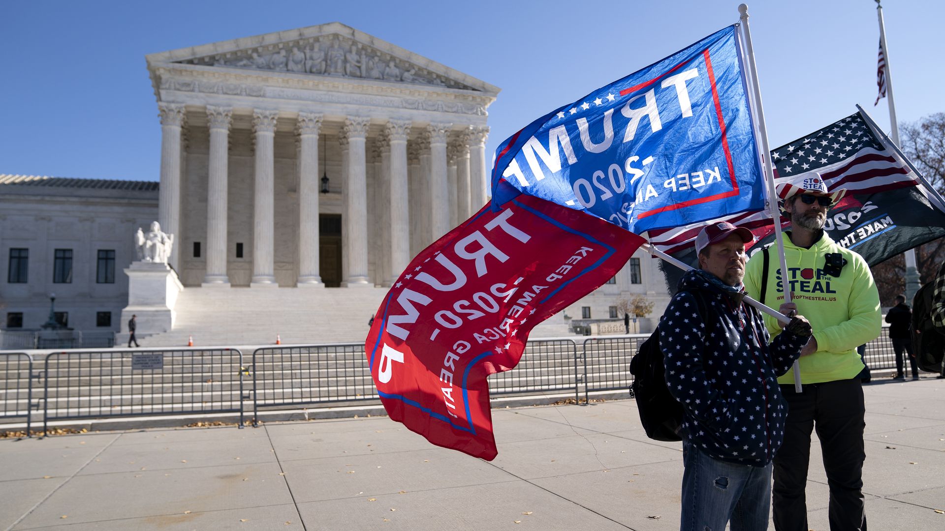 Trump supporters wave flags outside of the Supreme Court building after the 2020 presidential election.