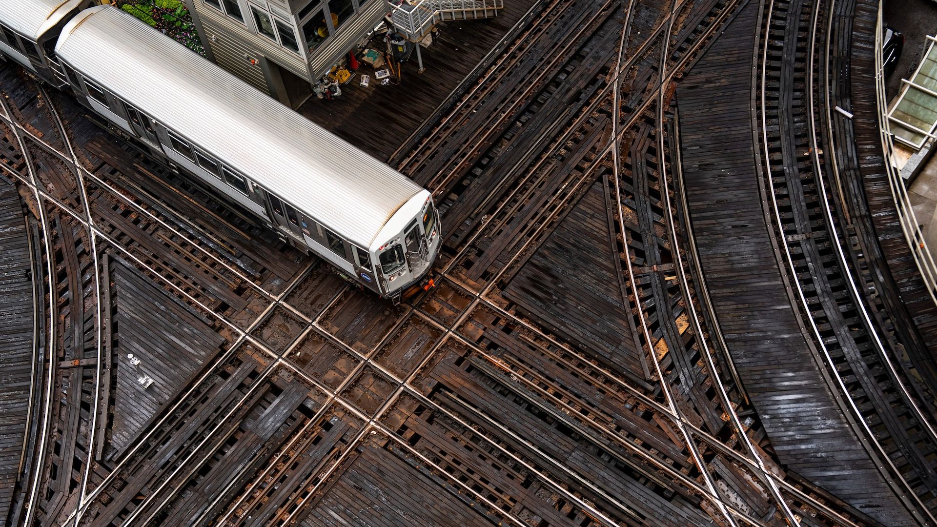 An aerial photo of a CTA train on criss crossing tracks.