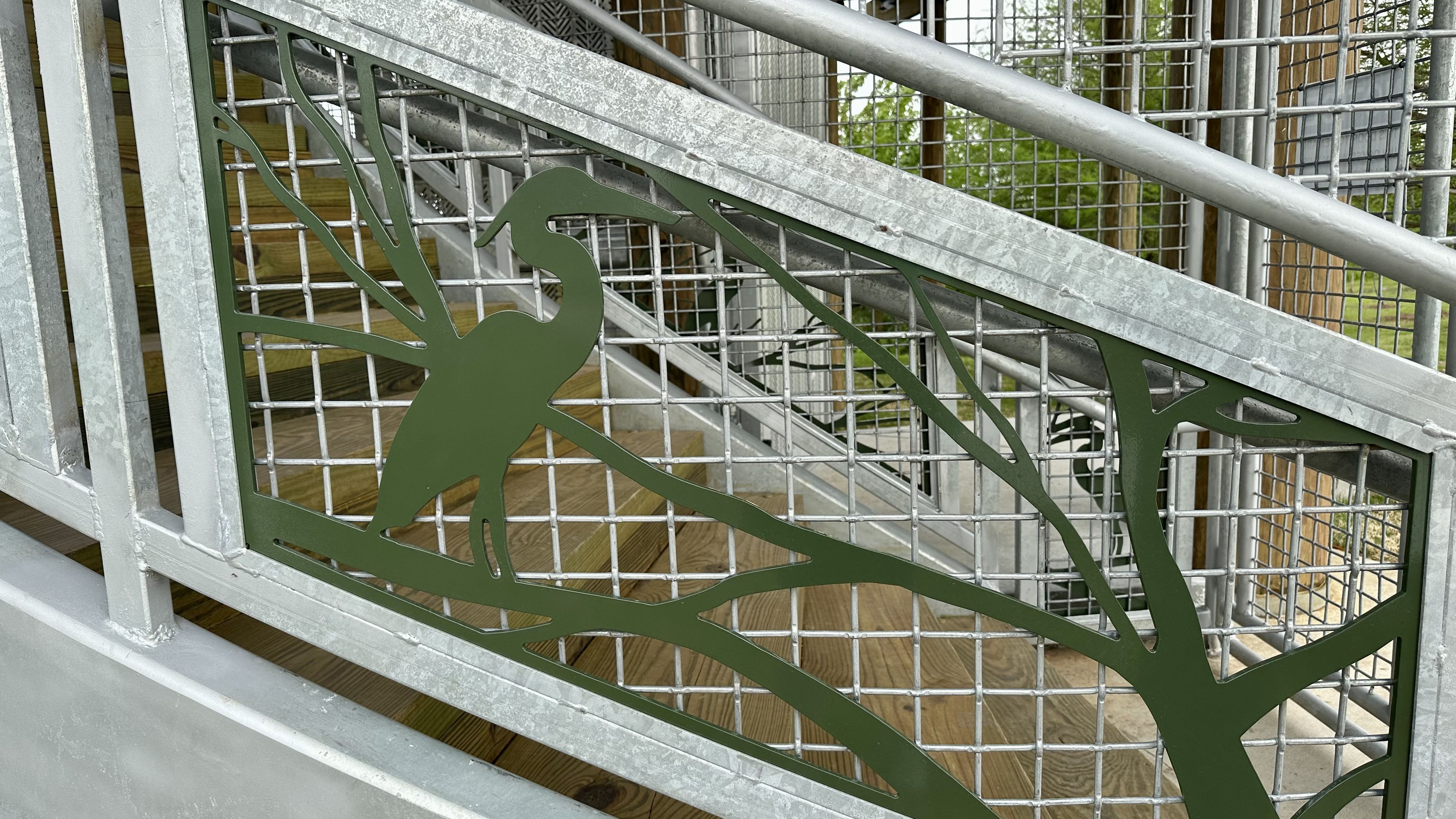 Photo shows metal birds and trees that decorate the staircase of the Bird's Nest.