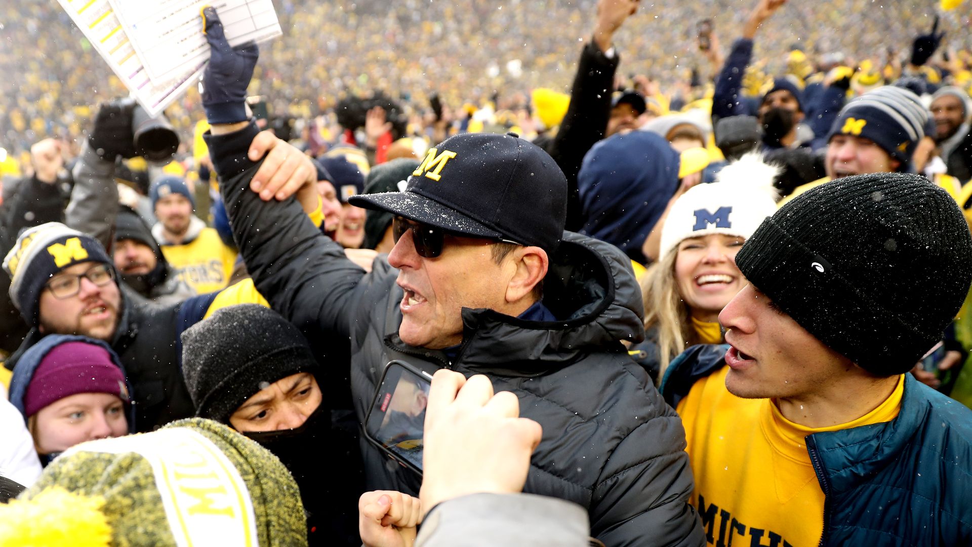 Michigan coach Jim Harbaugh celebrates with fans after last year's win over Ohio State