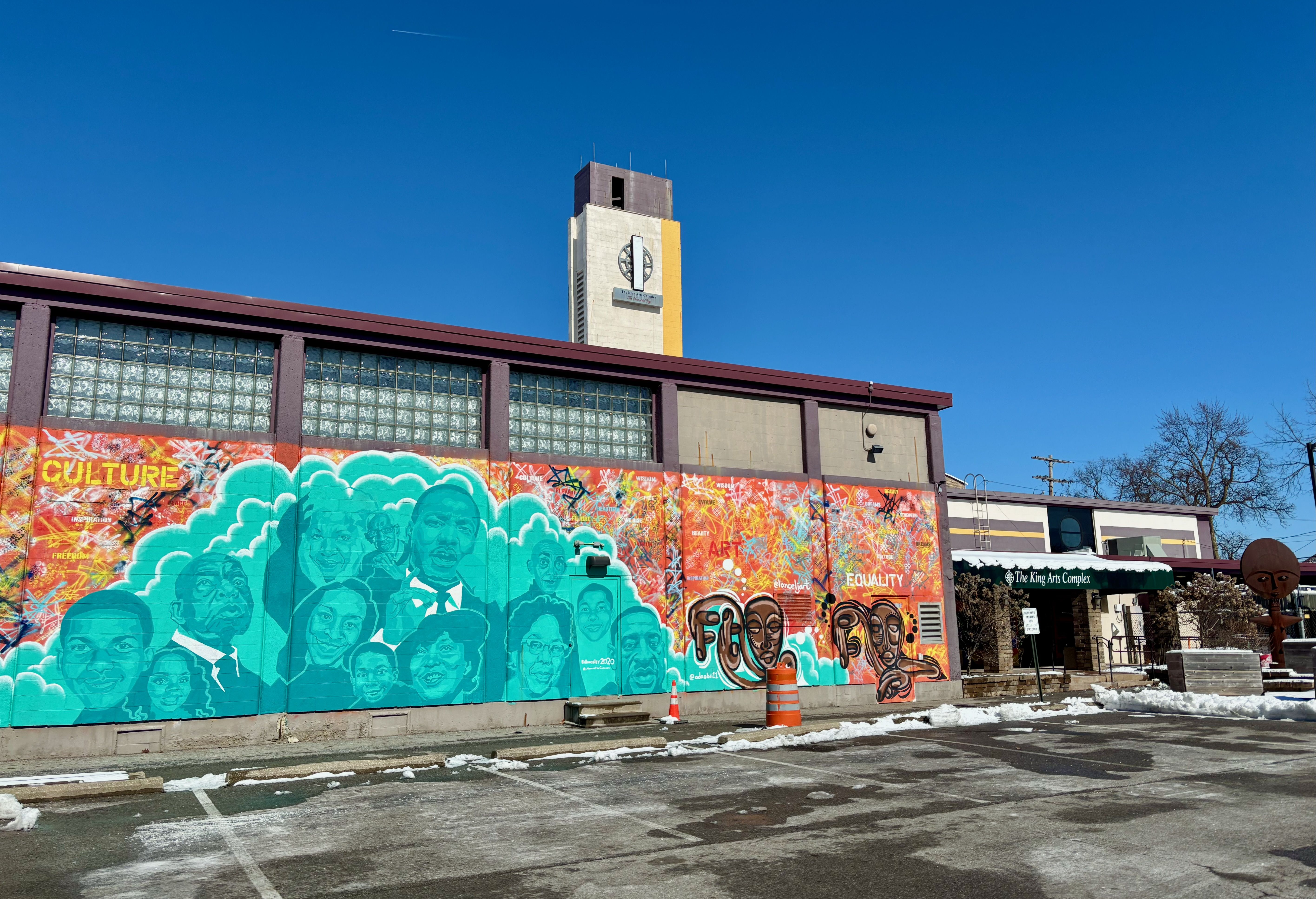 The front of the King Arts Complex, decorated with a colorful mural that reads "culture" with Black icons on it